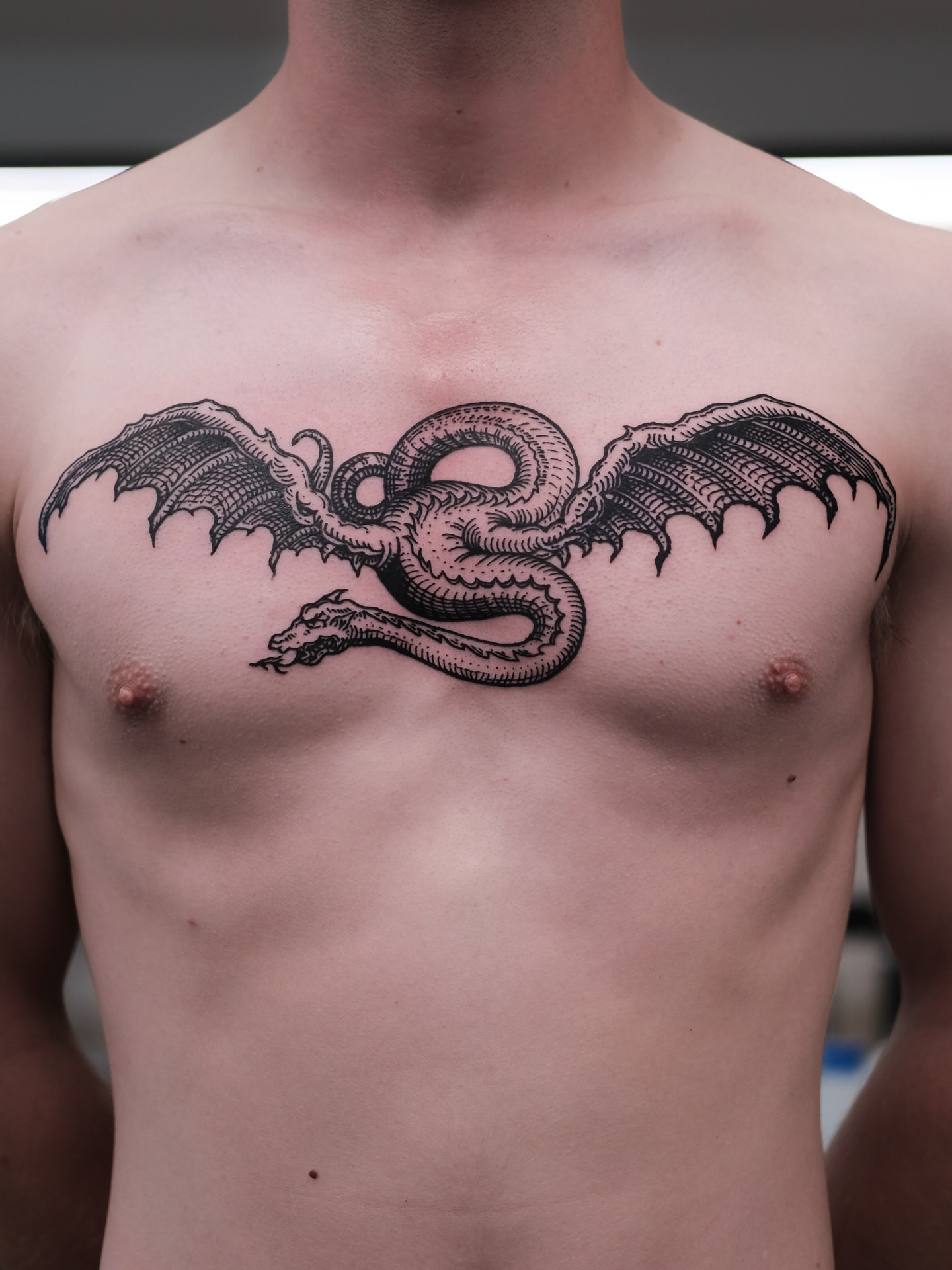 Dragon black and grey tattoo on the chest by ꜰʟᴏʀᴀ ᴡᴏᴏᴅᴄᴜᴛ ᴛᴀᴛᴛᴏᴏ