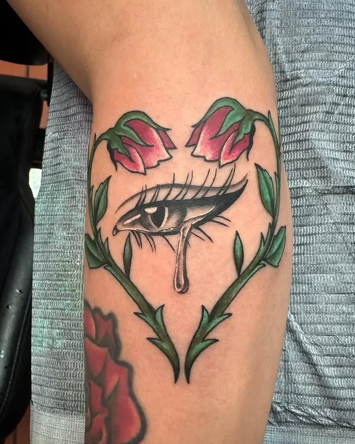 Eye with roses neo-traditional tattoo on the forearm by Greyson Heidenreich