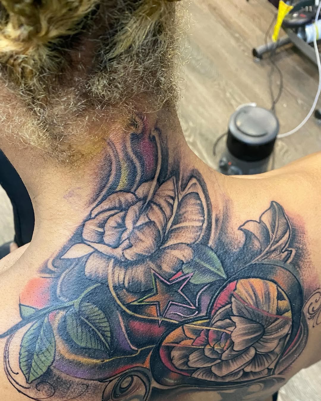 Rose and star tattoo on the shoulder by Watson Gutkowski