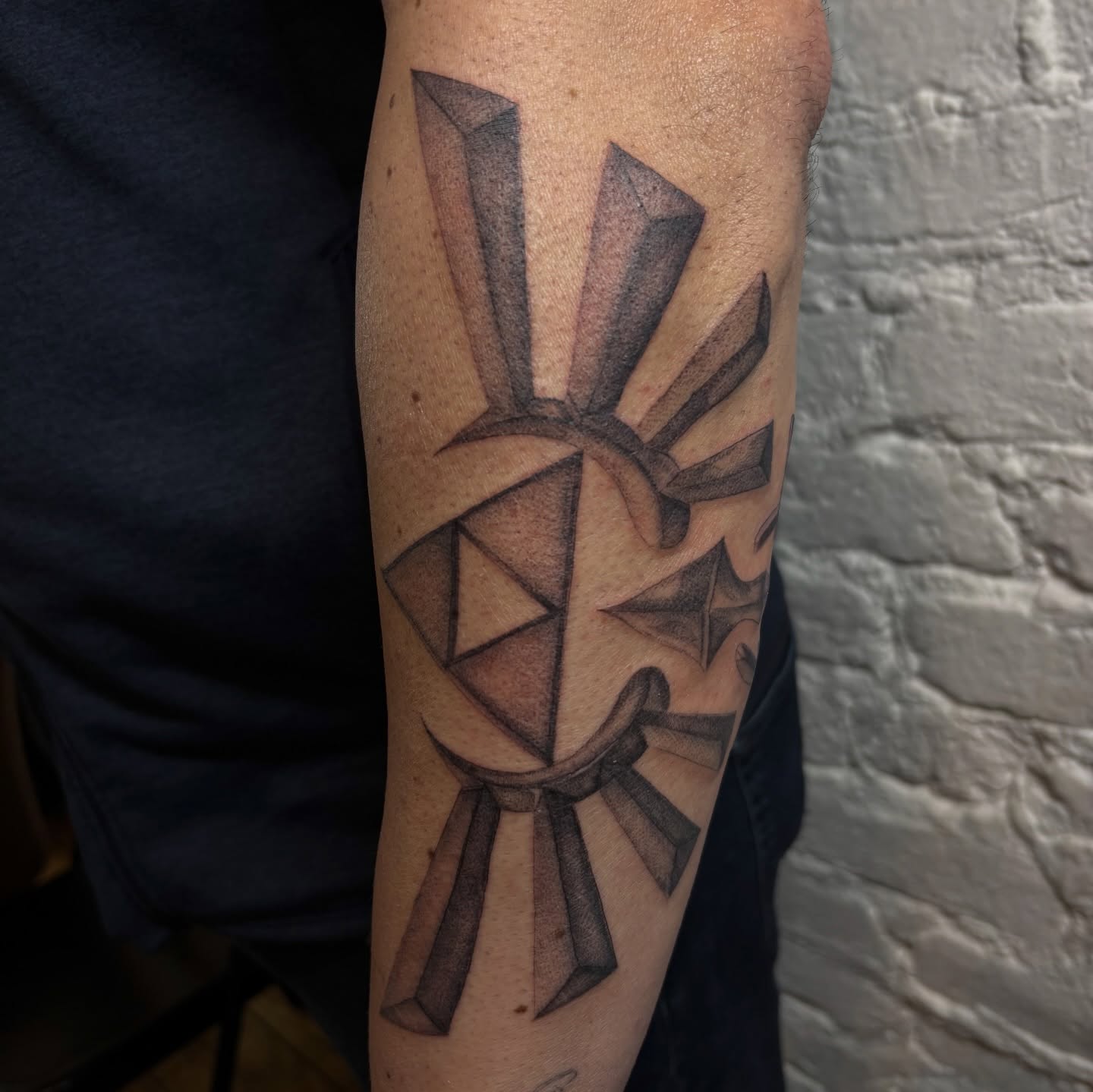 Geometric symbol geometric tattoo on the forearm by Sydney Gallucci