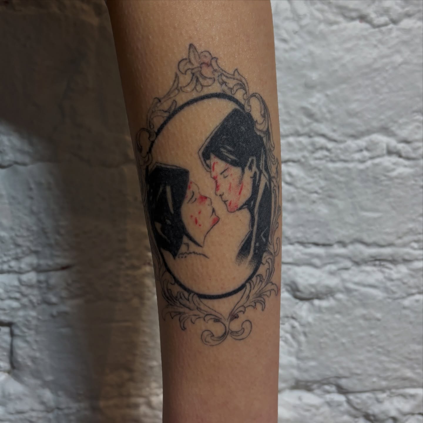 Mother and child black and grey tattoo on the forearm by Sydney Gallucci