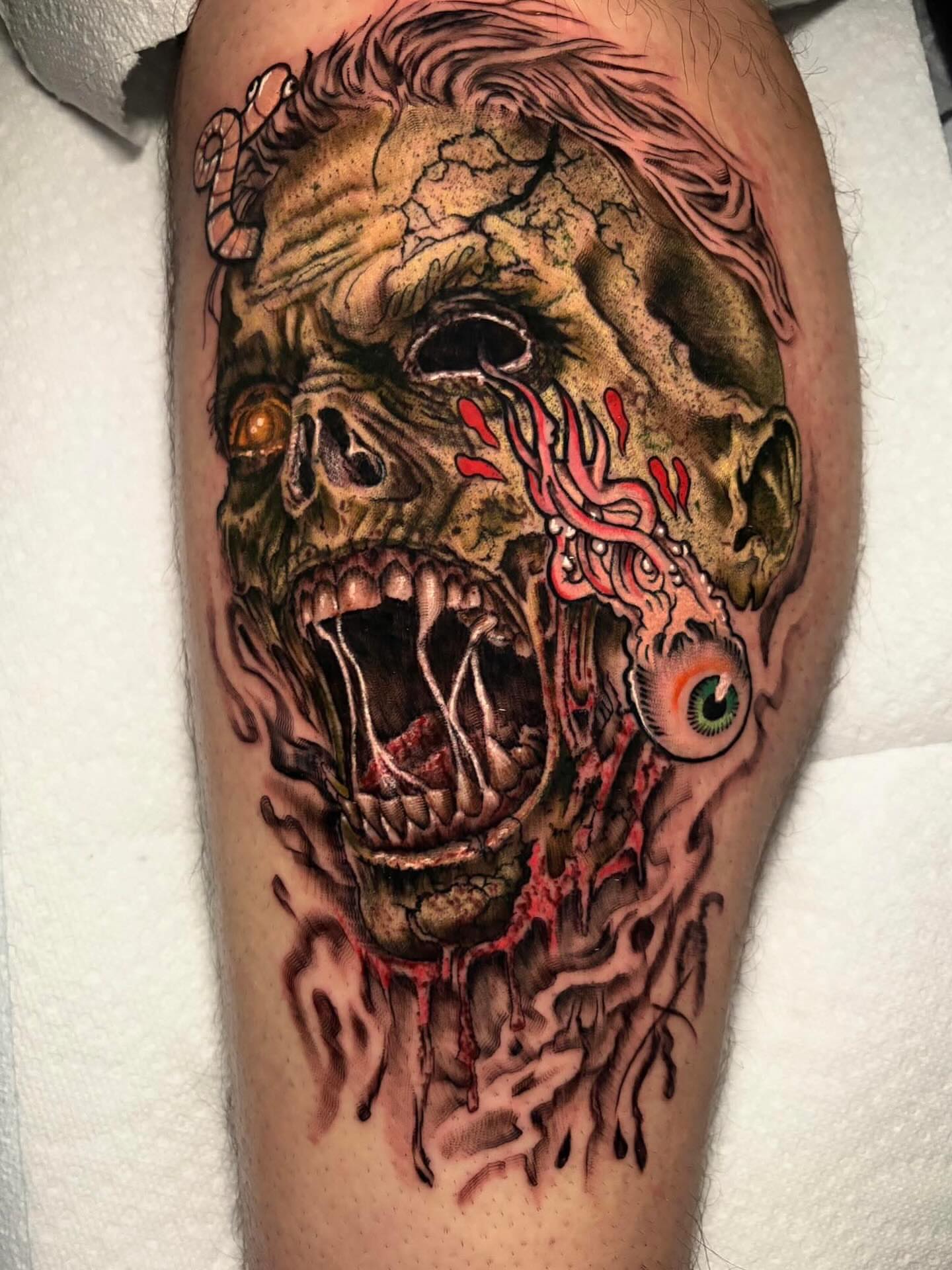 Zombie head dark realism tattoo on the thigh by James Richardson