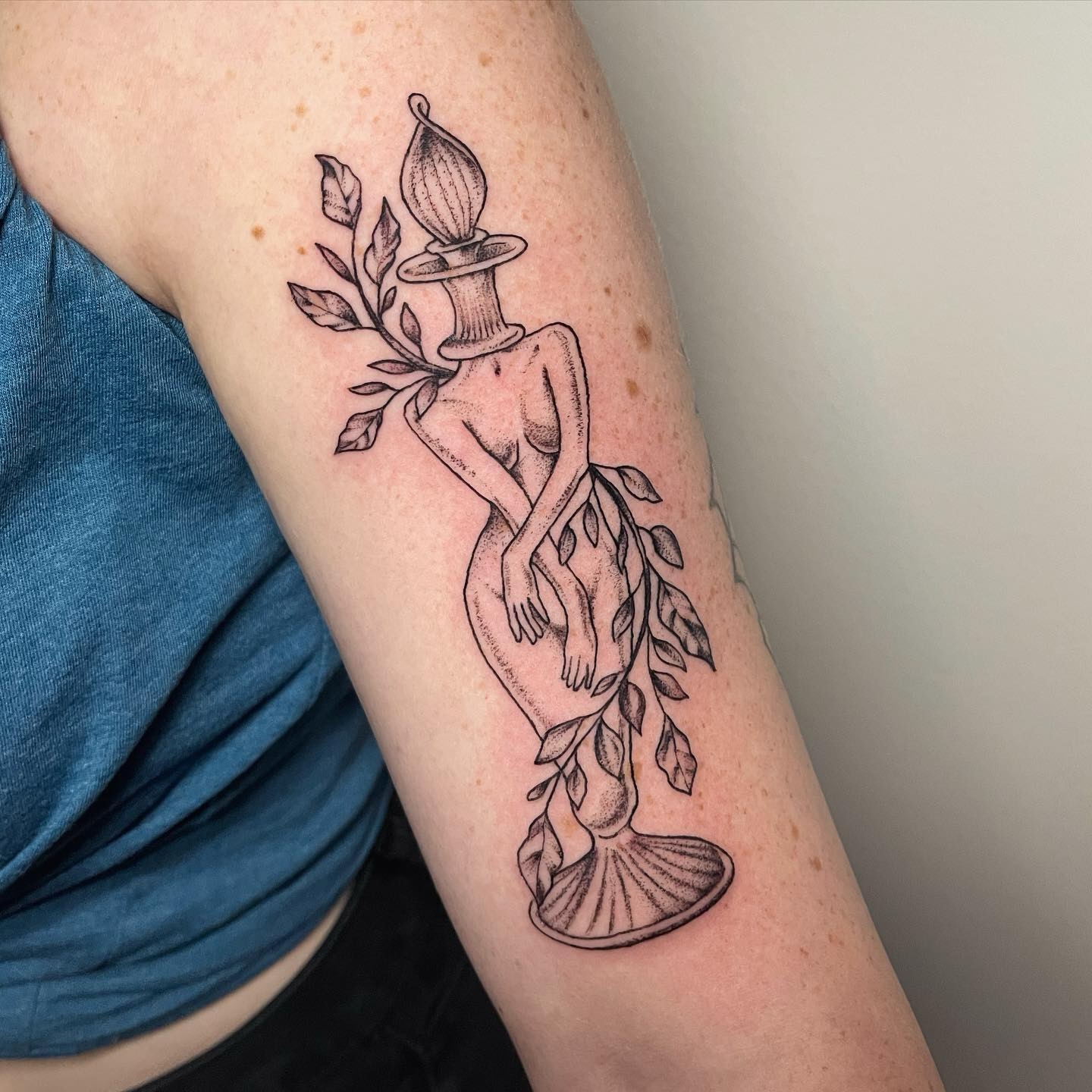 Nude female figure with candle black and grey tattoo on the forearm by Brandie