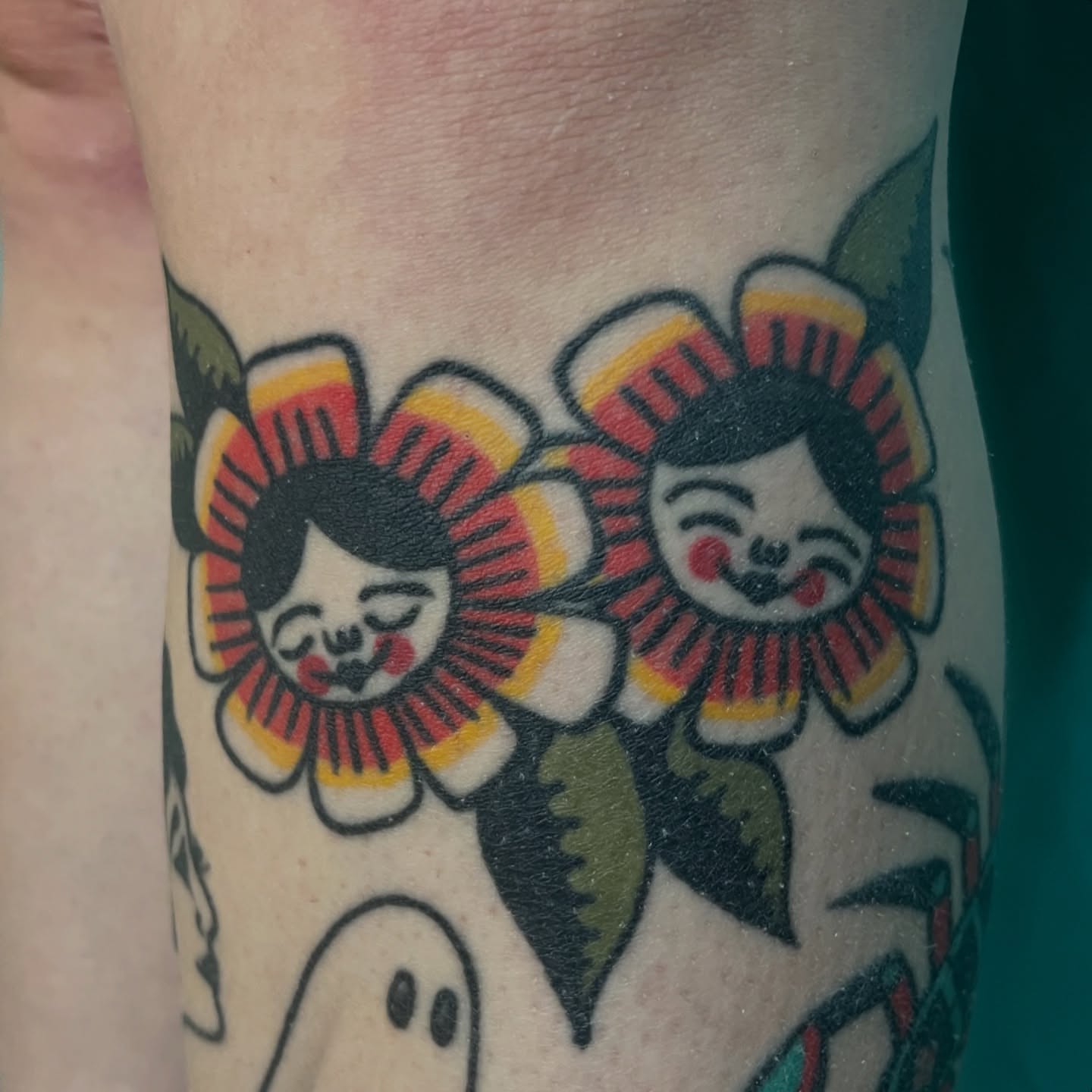 Geisha heads in flowers American traditional tattoo on the forearm by Kaily McKee