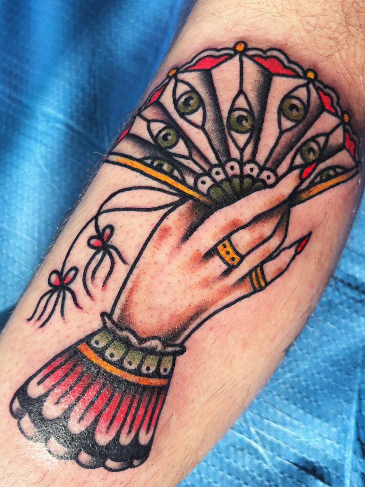Peacock feather American traditional tattoo on the forearm by Alex Green, Nashville, Tennessee