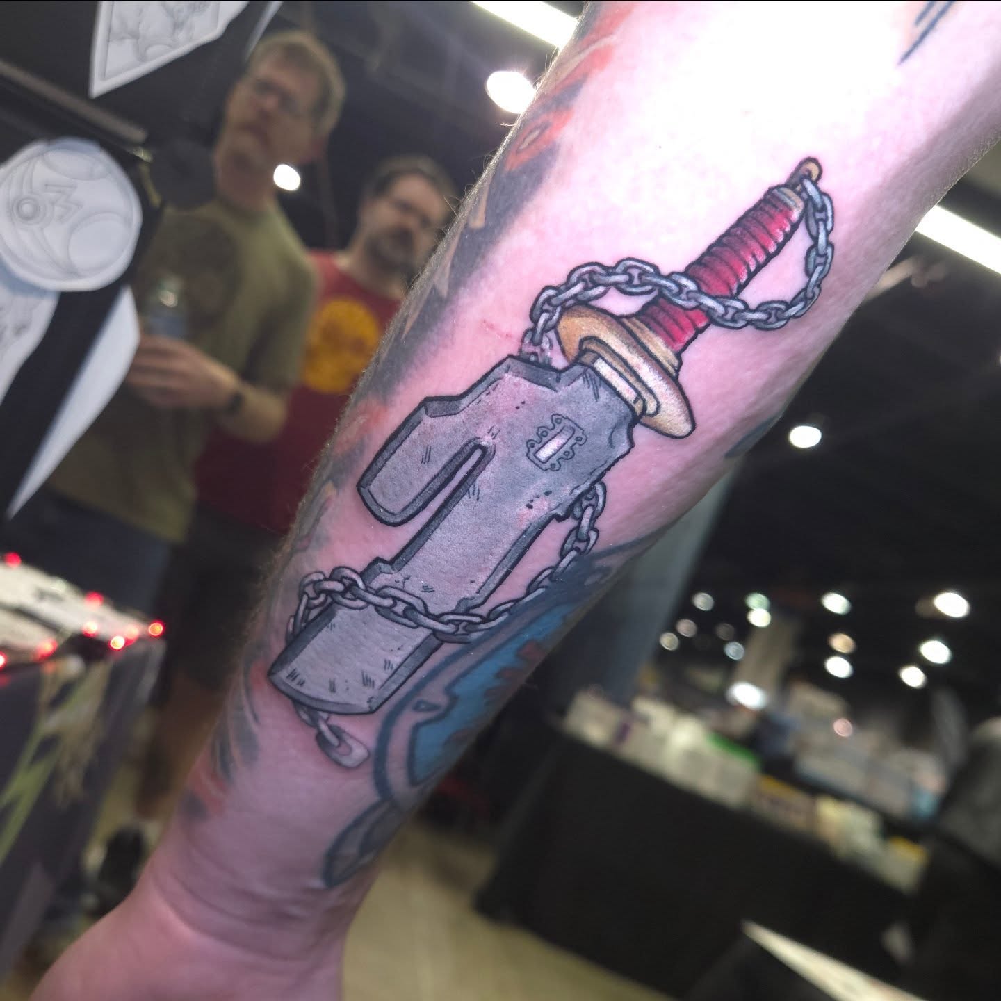 Sword and chain American traditional tattoo on the forearm by Nic Mann