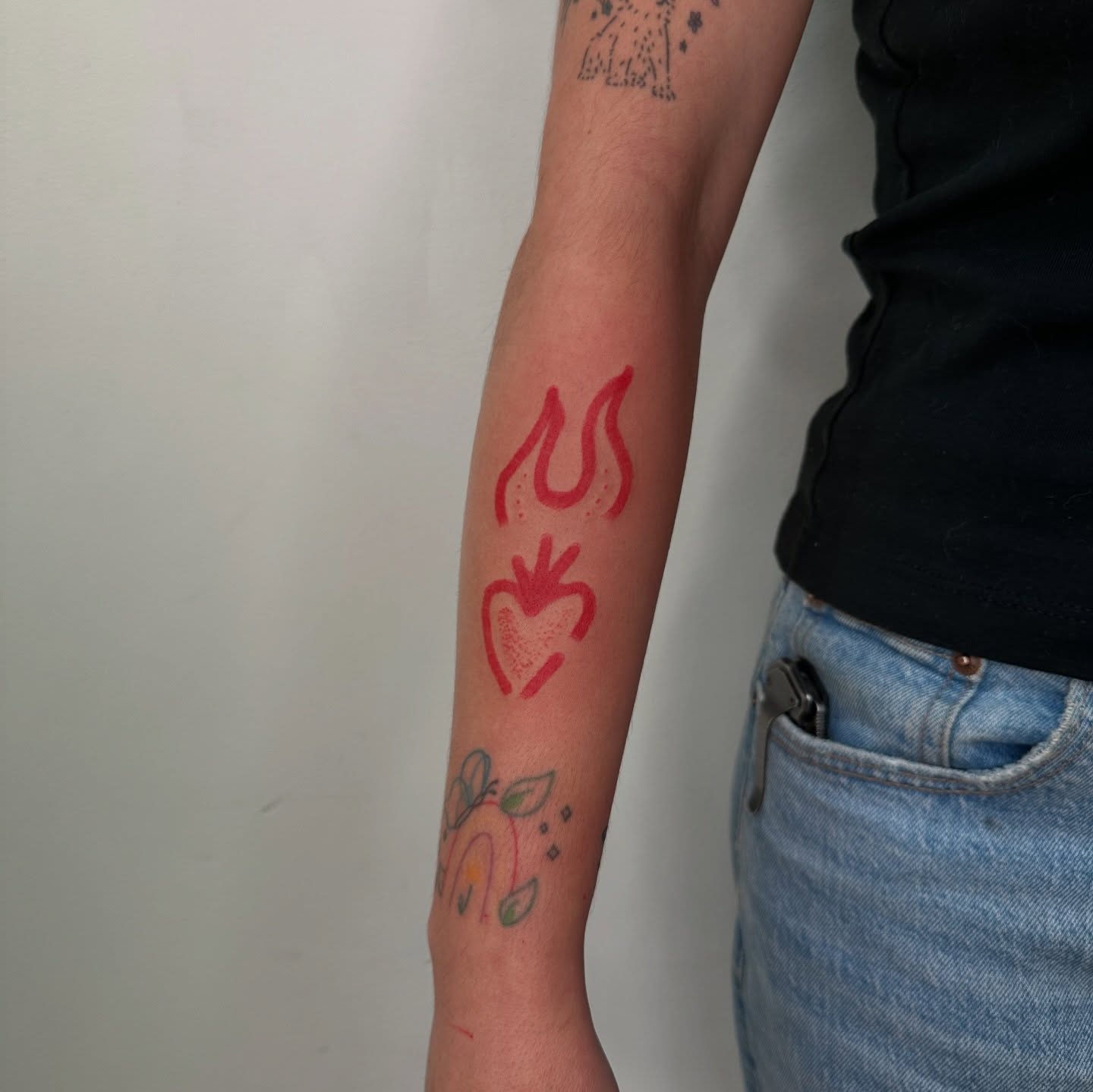 Flame and heart dotwork tattoo on the forearm by paulina