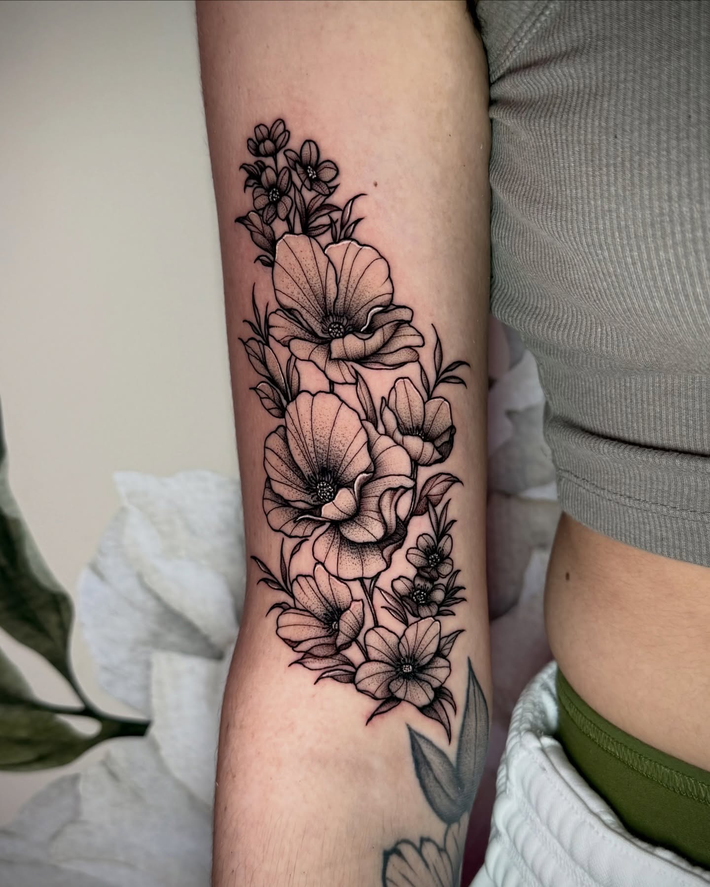 Floral bouquet black and grey tattoo on the forearm by Emily‹𝟹