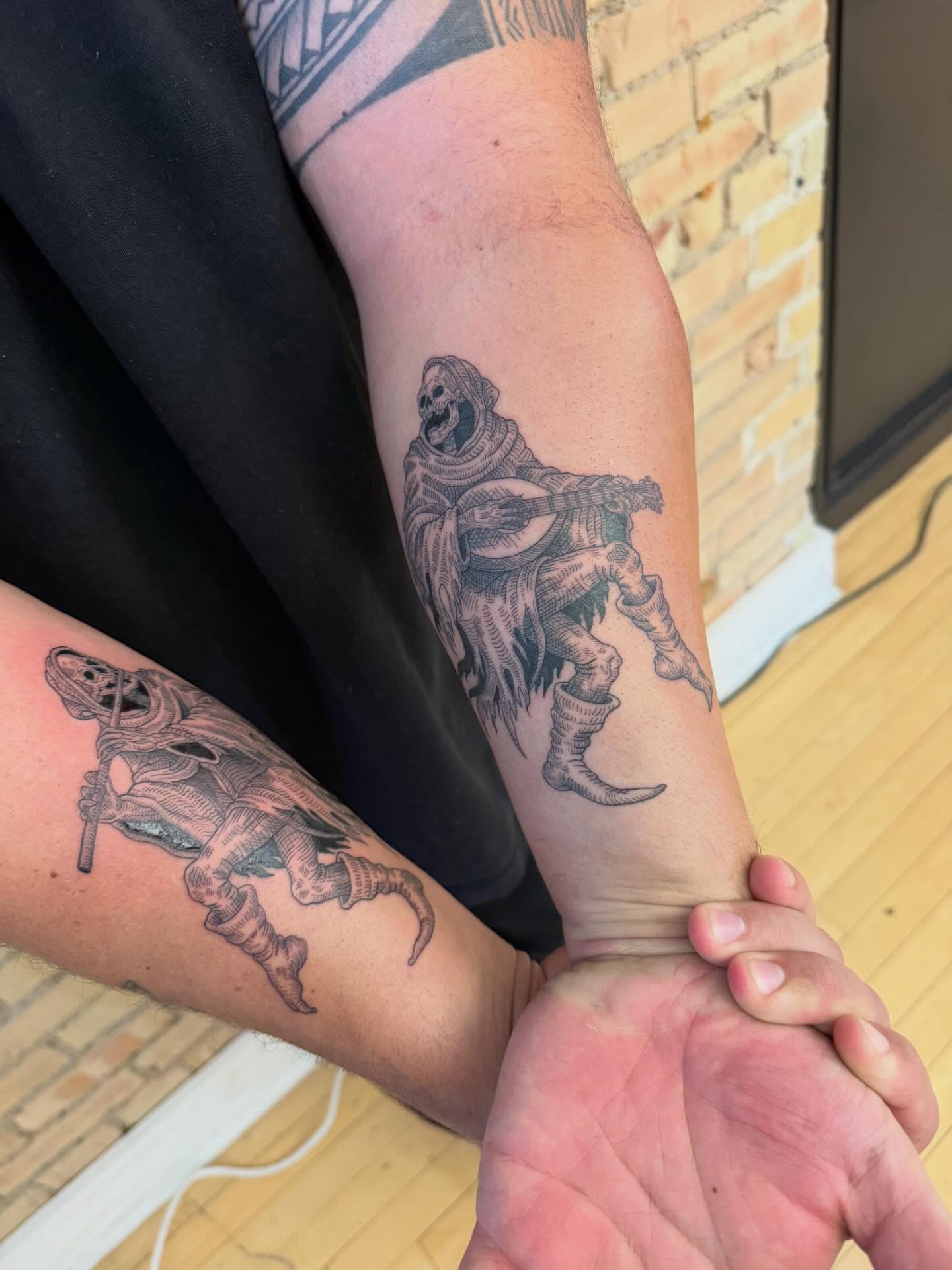 Reaper playing banjo black and grey tattoo on the forearm by Dre