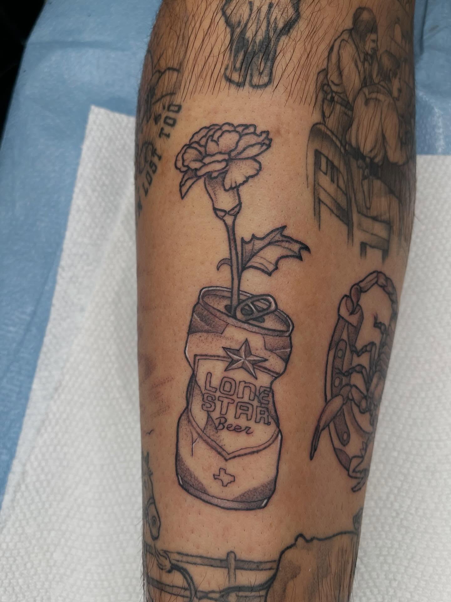 Lone Star beer can with rose black and grey tattoo on the forearm by Allison Gallagher