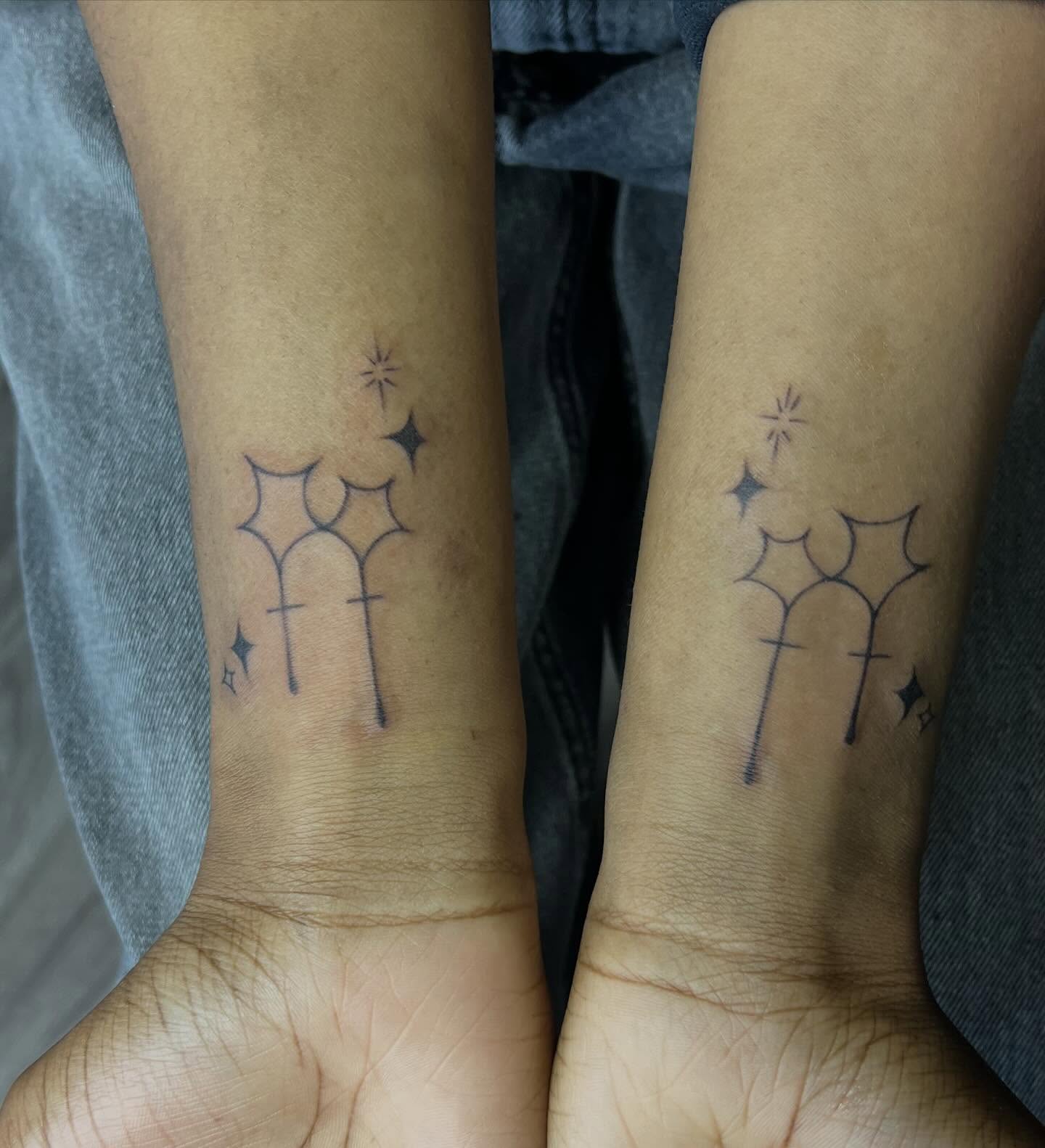 Wands and stars black and grey tattoo on the forearm by Haiiitattoo