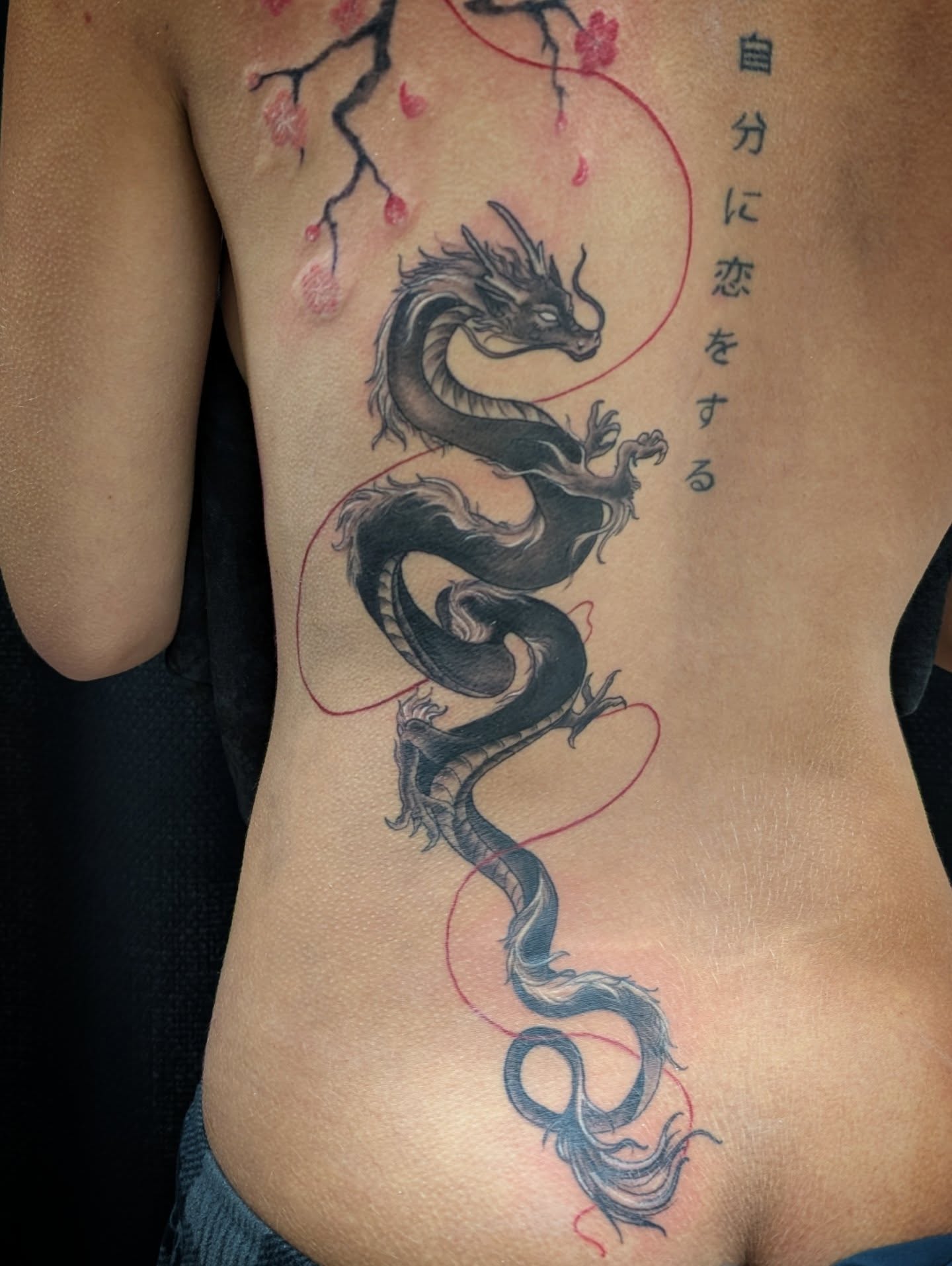 Dragon and cherry blossoms japanese irezumi tattoo on the ribs by Katherine