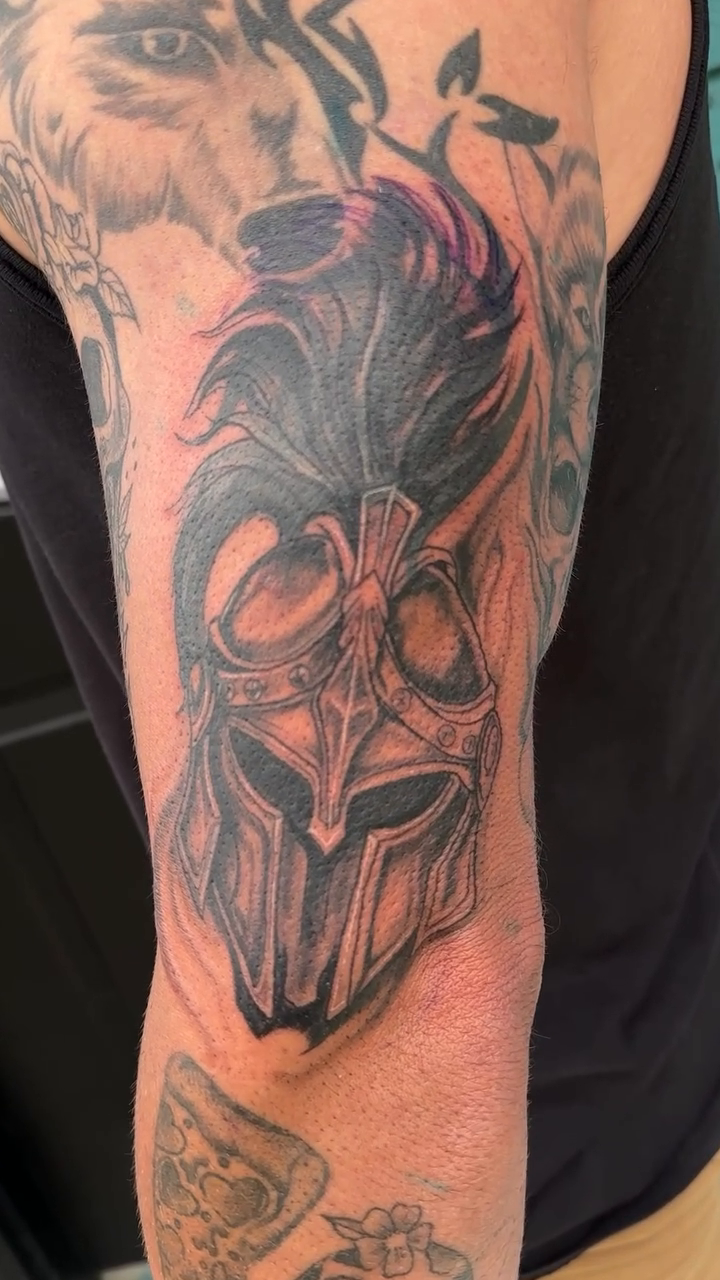 Masked warrior with mohawk realism tattoo on the forearm by Mika'la Berry