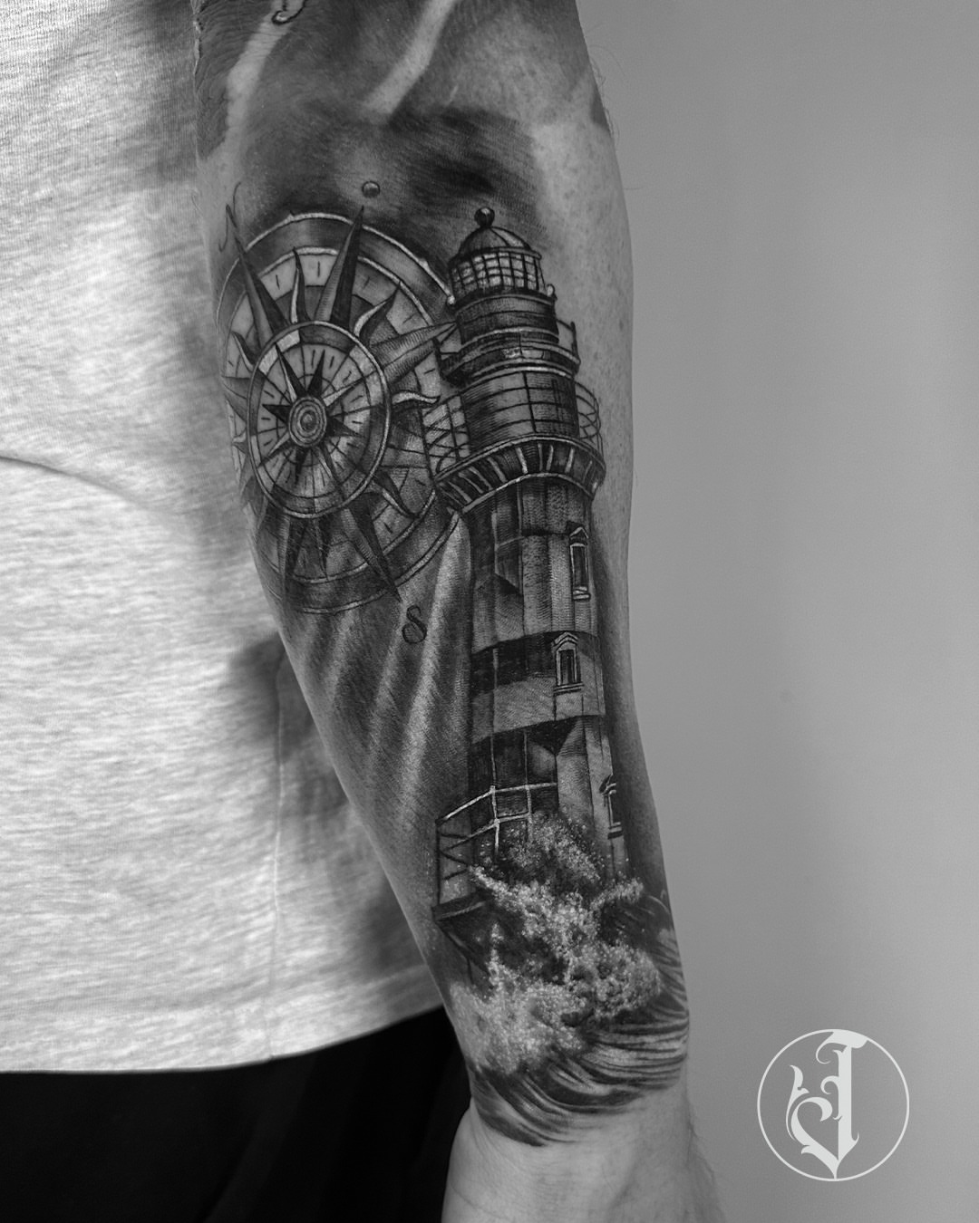 Lighthouse and compass realism tattoo on the forearm by Tattoos By Josh