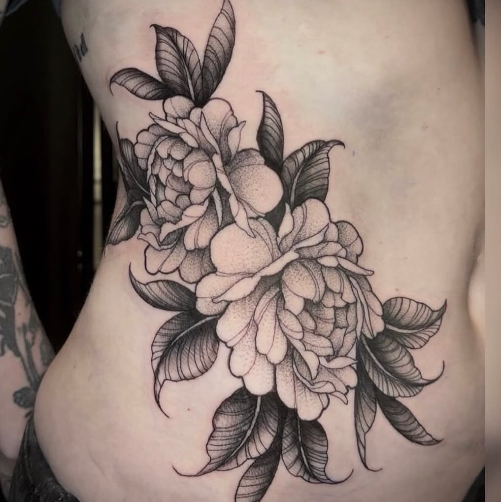 Peony flowers dotwork tattoo on the ribs by Alyssa Deeghan