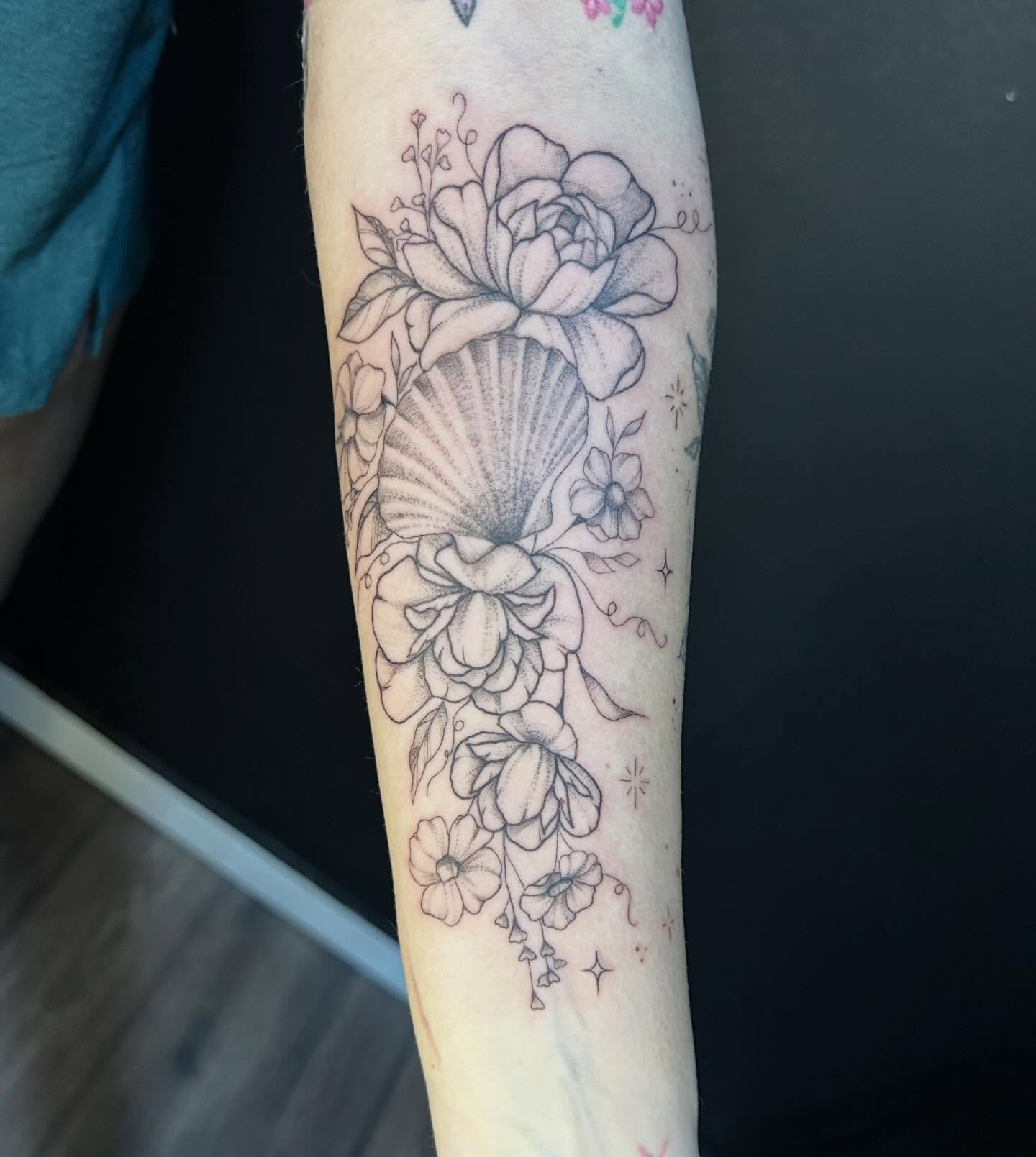 Seashell and floral bouquet realism tattoo on the forearm by Elizabeth (Lib), Murfreesboro, Tennessee