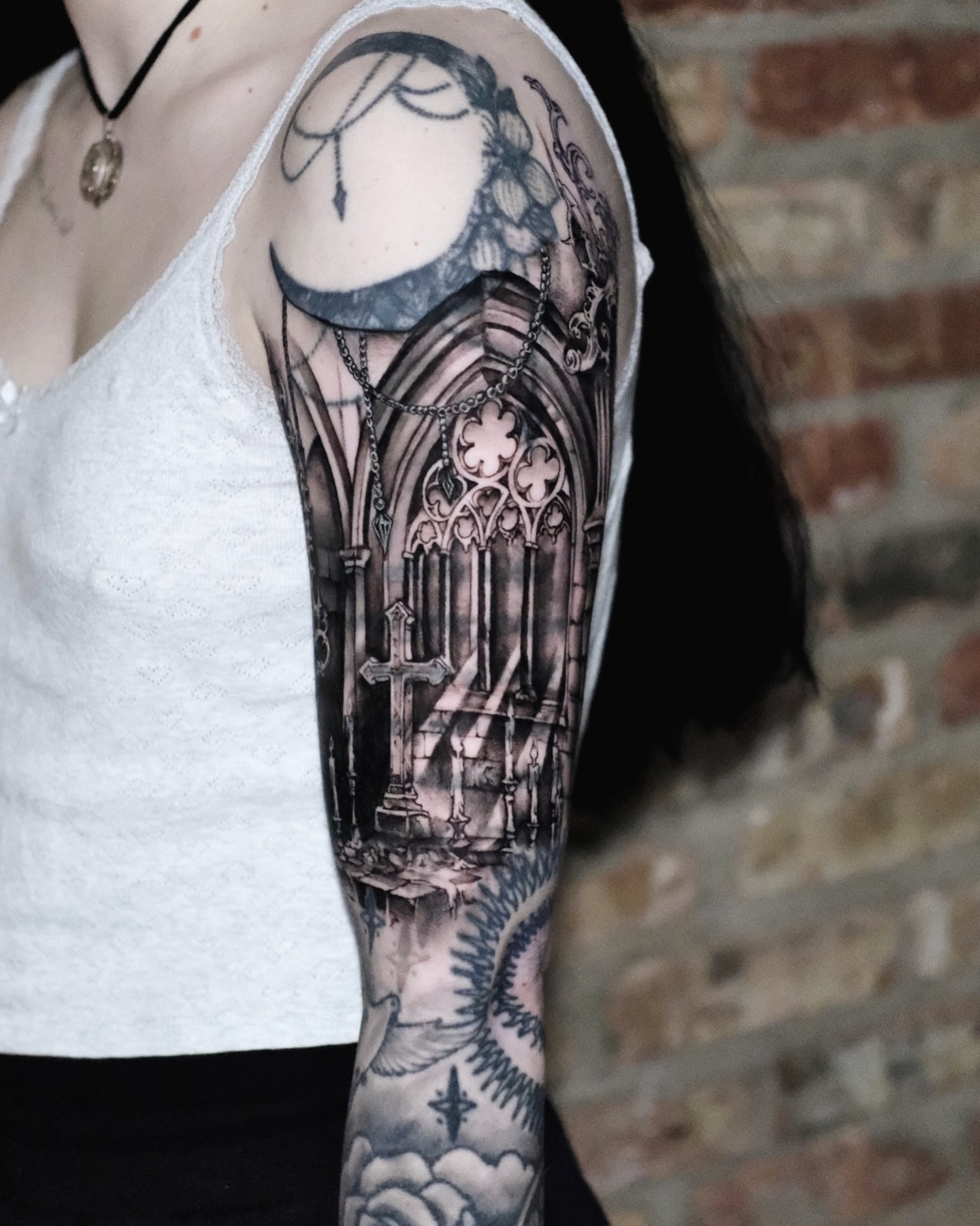 Gothic chapel realism tattoo on the forearm by Macayla Myers