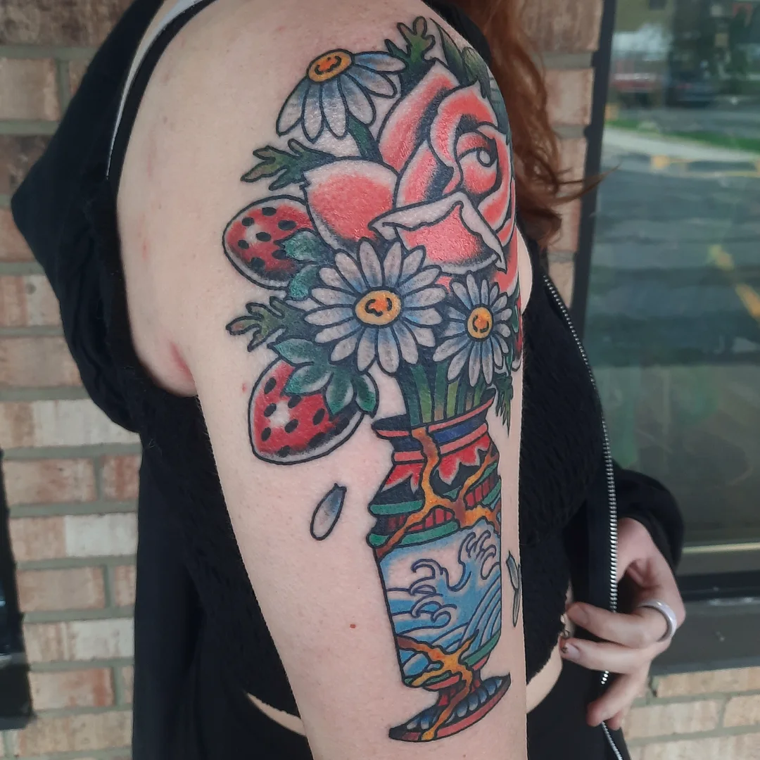 Flower bouquet American traditional tattoo on the upper arm by Kaetlyn