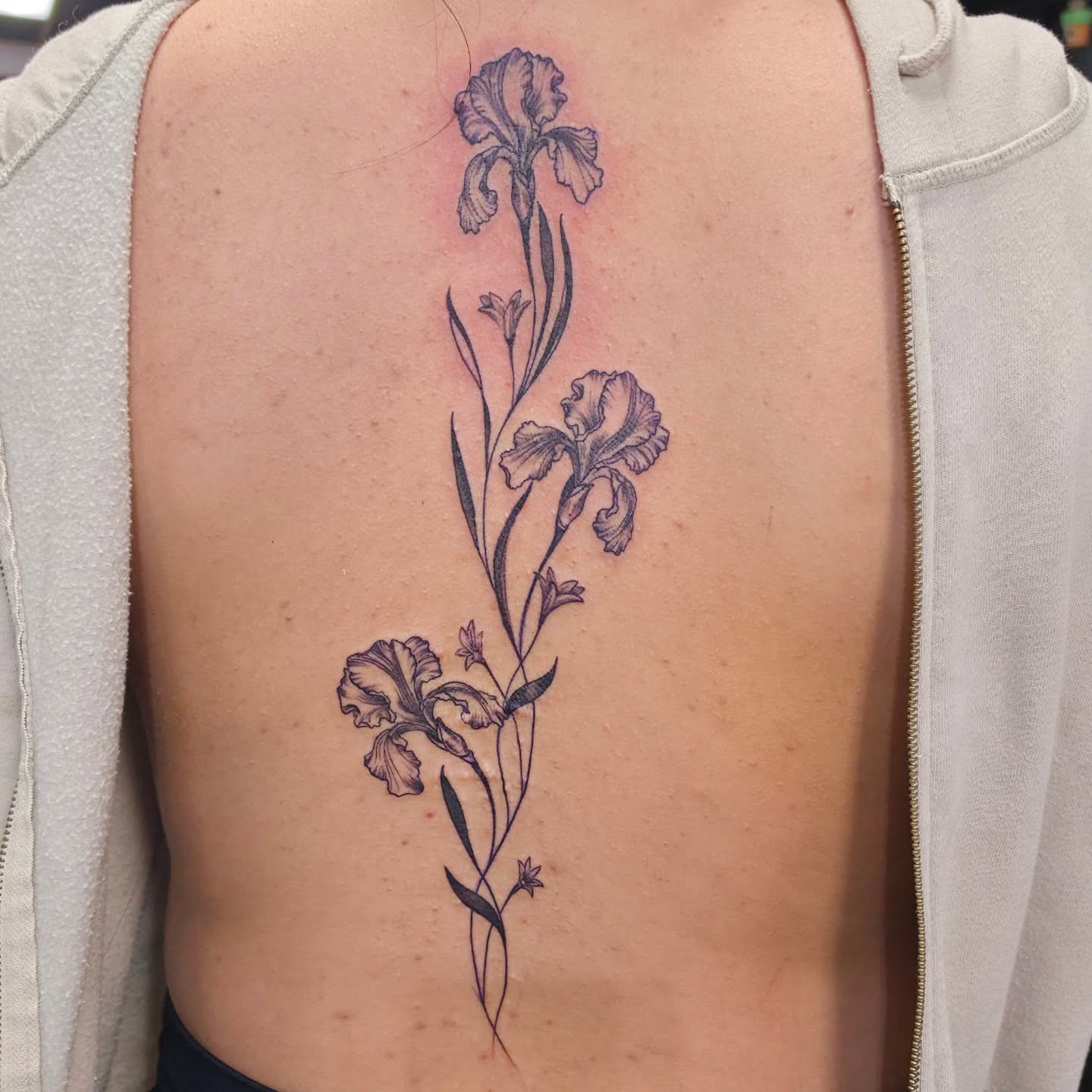 Iris black and grey tattoo on the back by Robert Glover