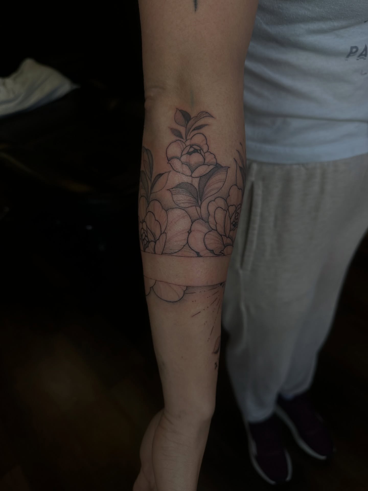 Floral bouquet black and grey tattoo on the forearm by Priscilla Michels