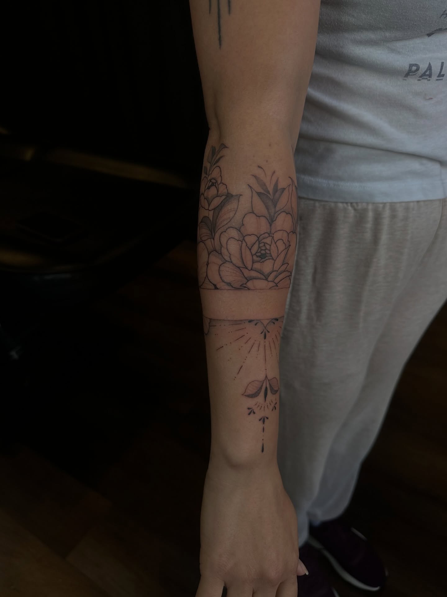 Floral bouquet black and grey tattoo on the forearm by Priscilla Michels