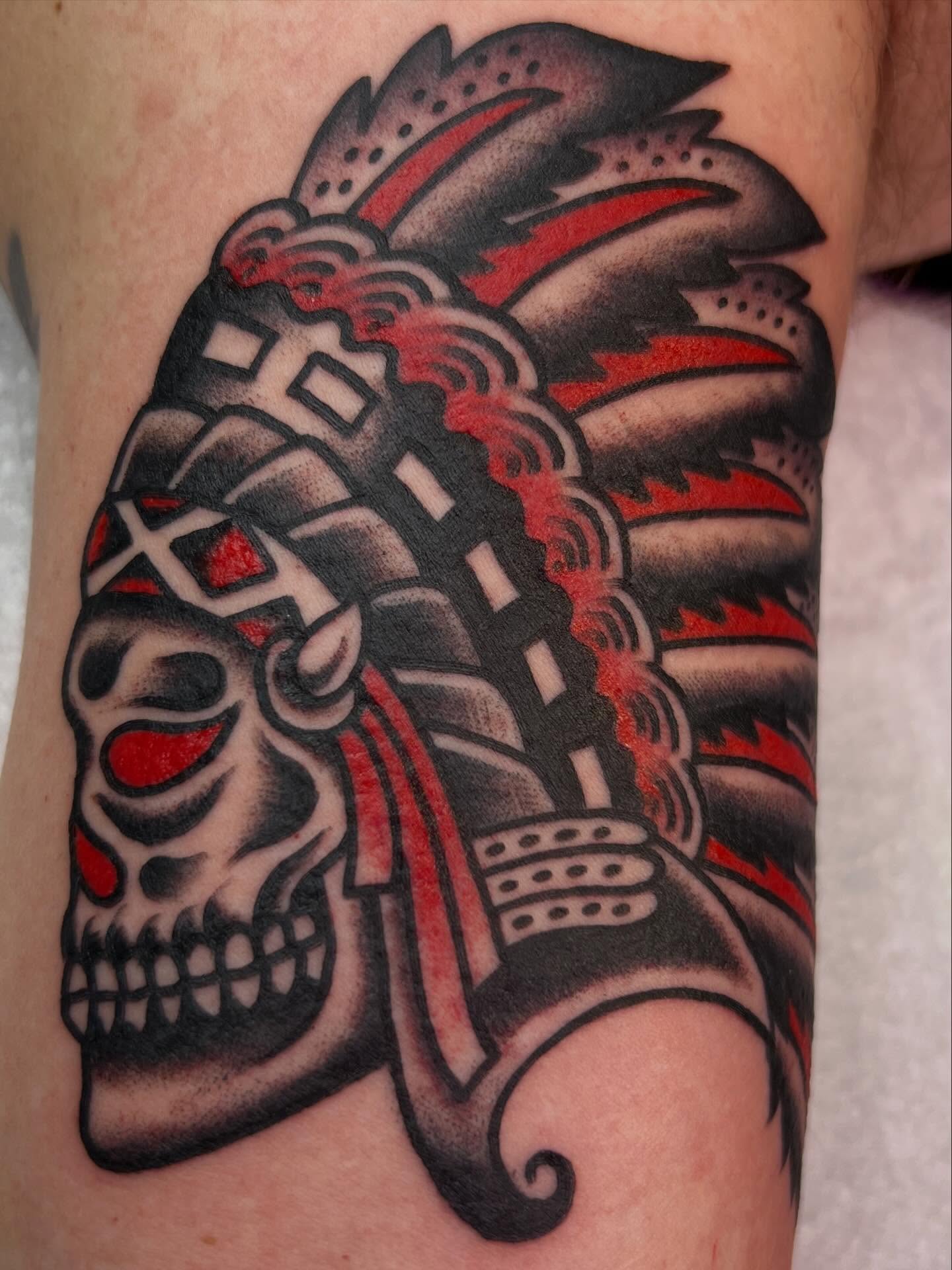 Skull with headdress American traditional tattoo on the forearm by Charlie Campanella