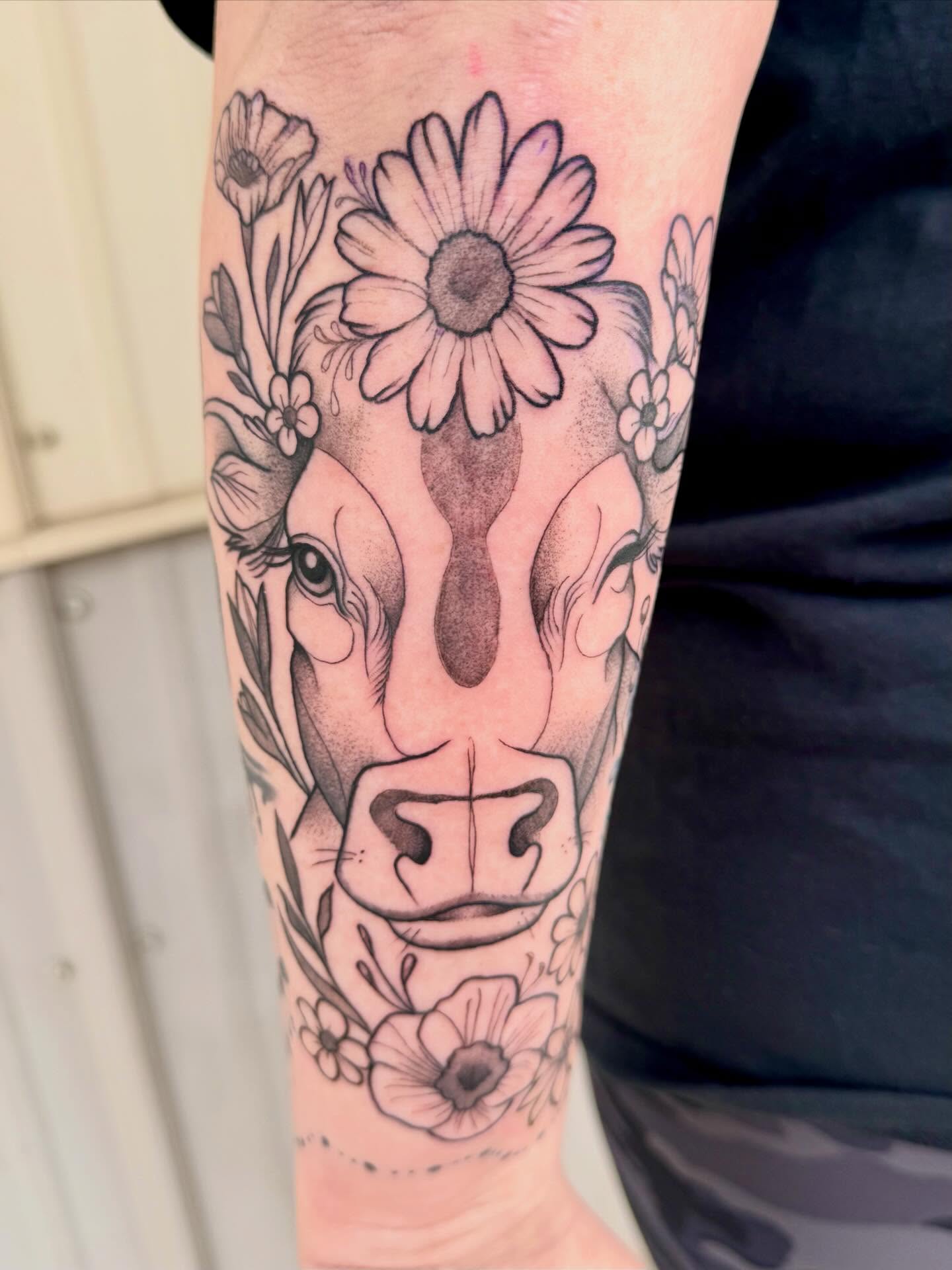 Warthog with flowers black and grey tattoo on the forearm by Kayla Rosencrans