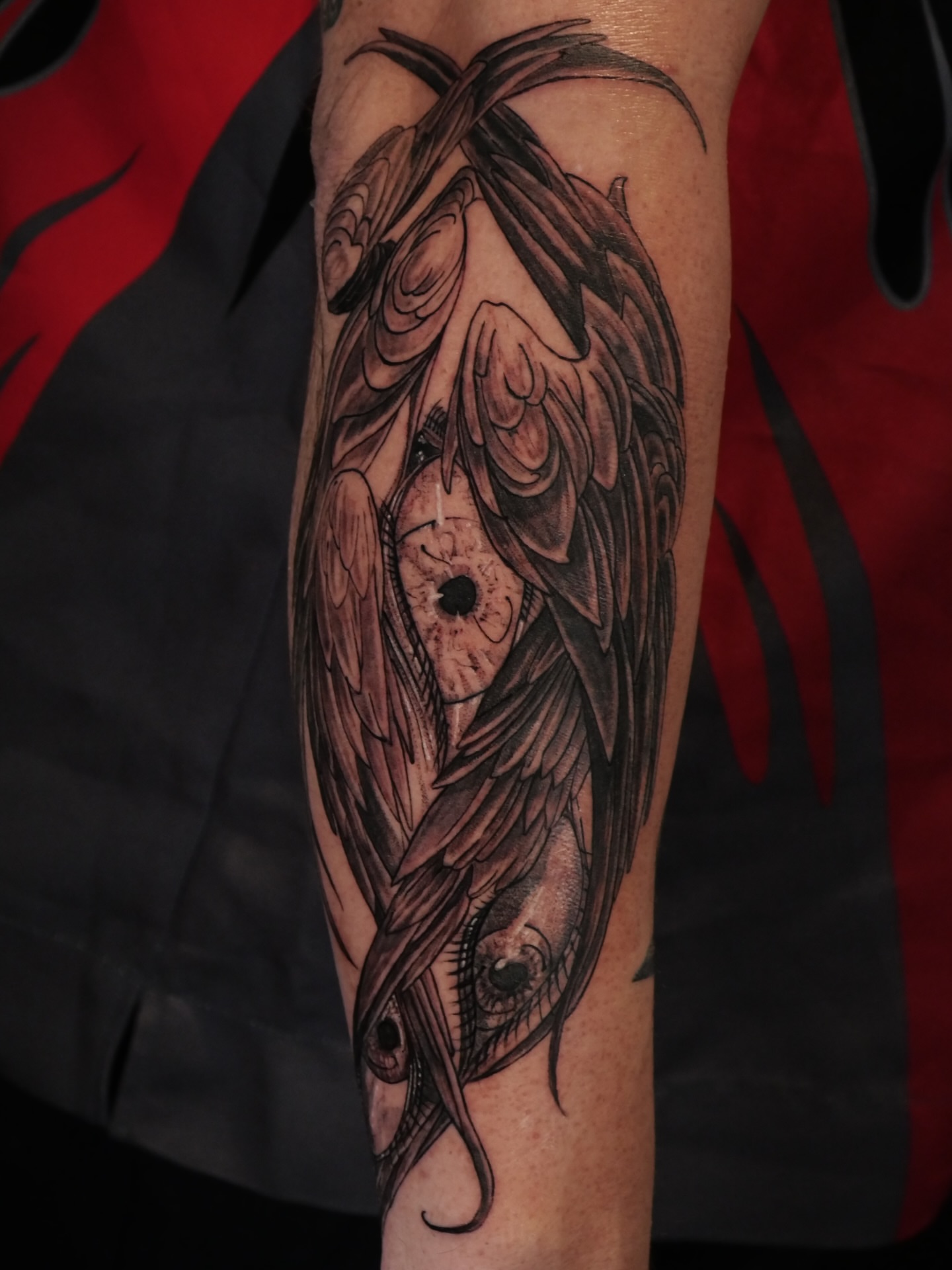 Eye with wings dark realism tattoo on the forearm by Sloppy