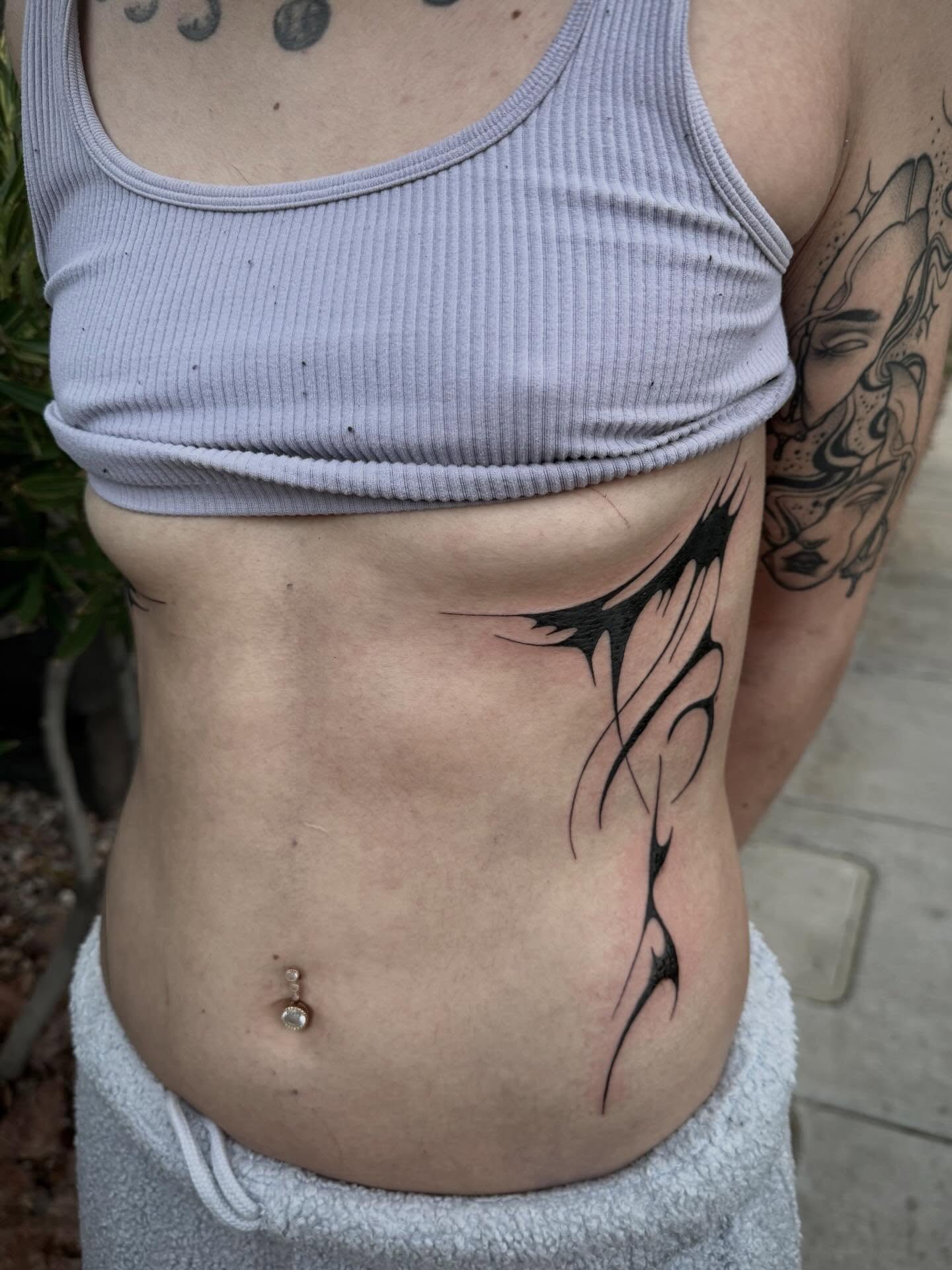 Tribal tribal tattoo on the torso by abbie michelle
