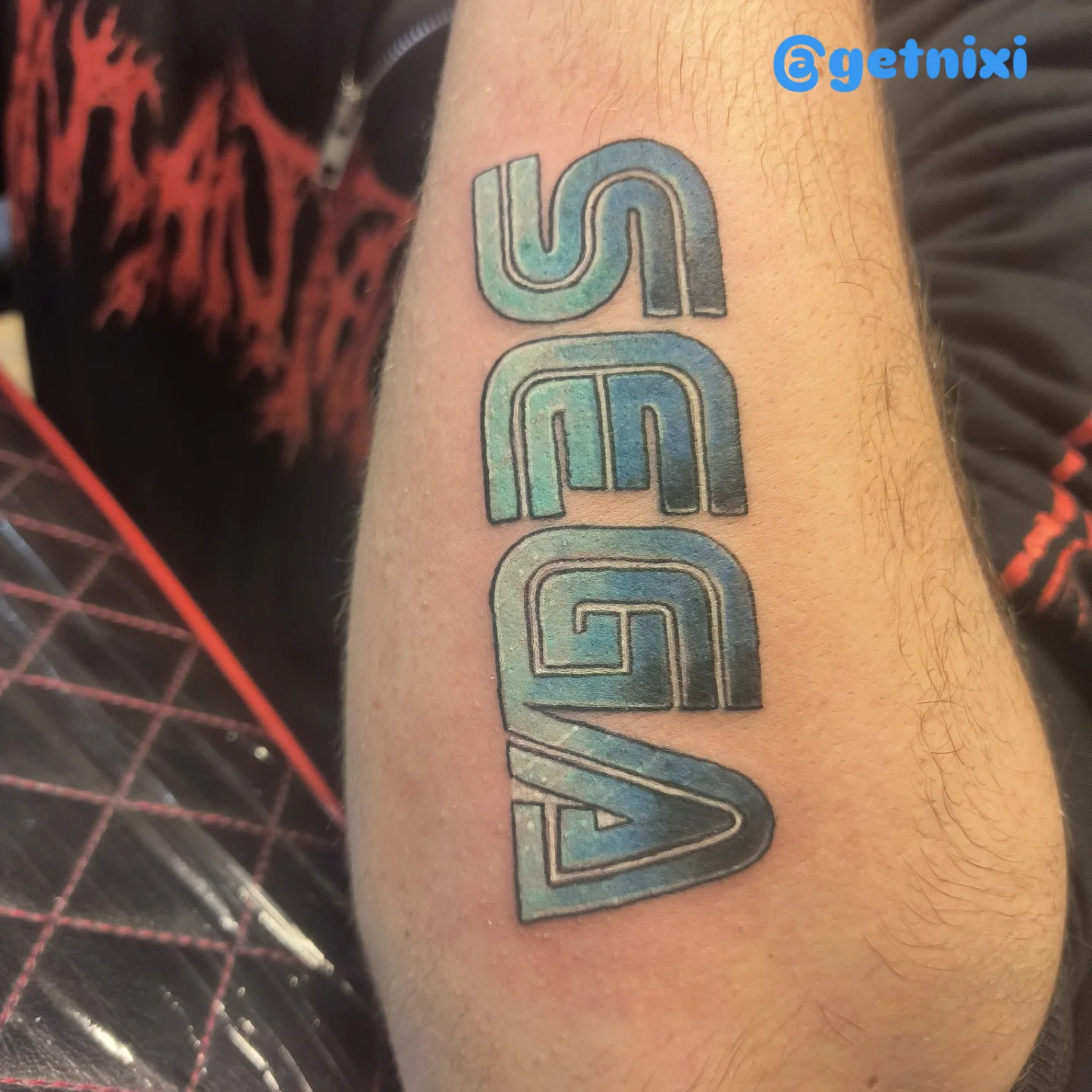 SEGA logo geometric tattoo on the forearm by Niki Jackson