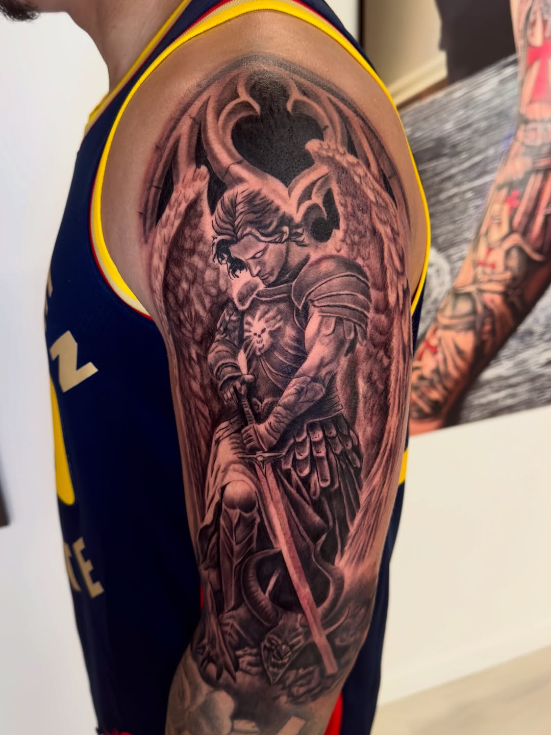 Angel with sword and dragon realism tattoo on the forearm by Brandon Patino