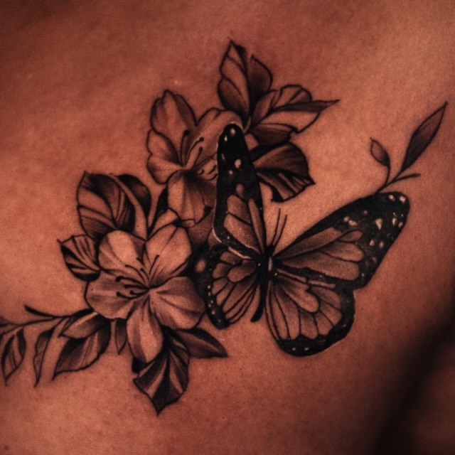 Butterfly and flowers black and grey tattoo on the chest by Shane Boss, Toronto, Ontario