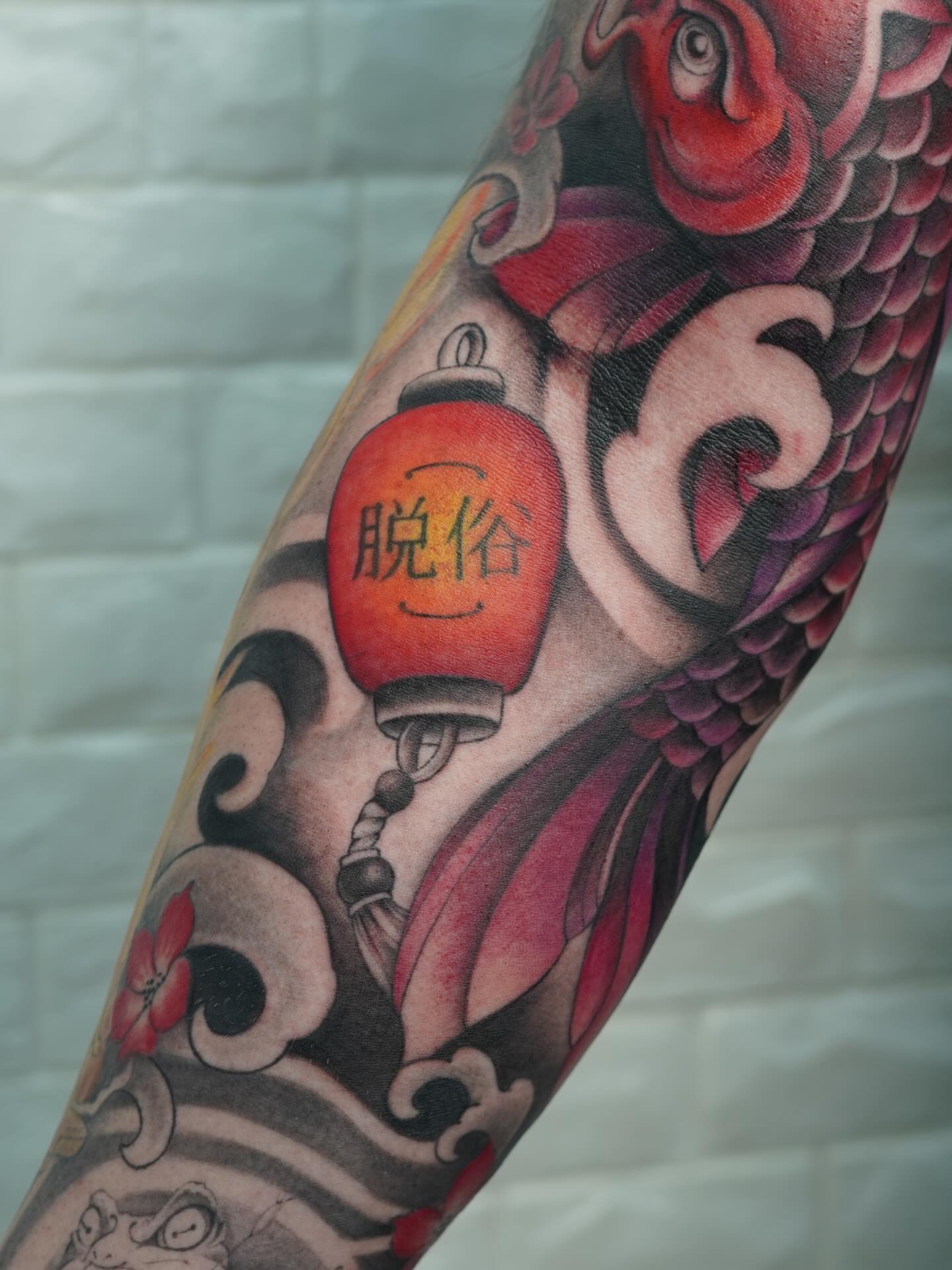 Koi fish and lantern japanese irezumi tattoo on the forearm by Danae Andino