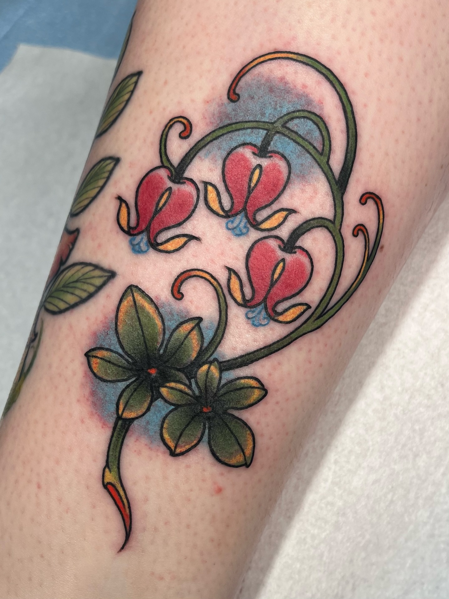 Lily flowers American traditional tattoo on the forearm by Allyson Blessing Tattoos