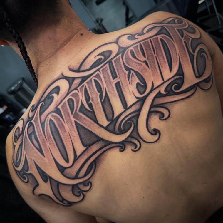 NORTHSD lettering script tattoo on the back by Chicanocustomlettering