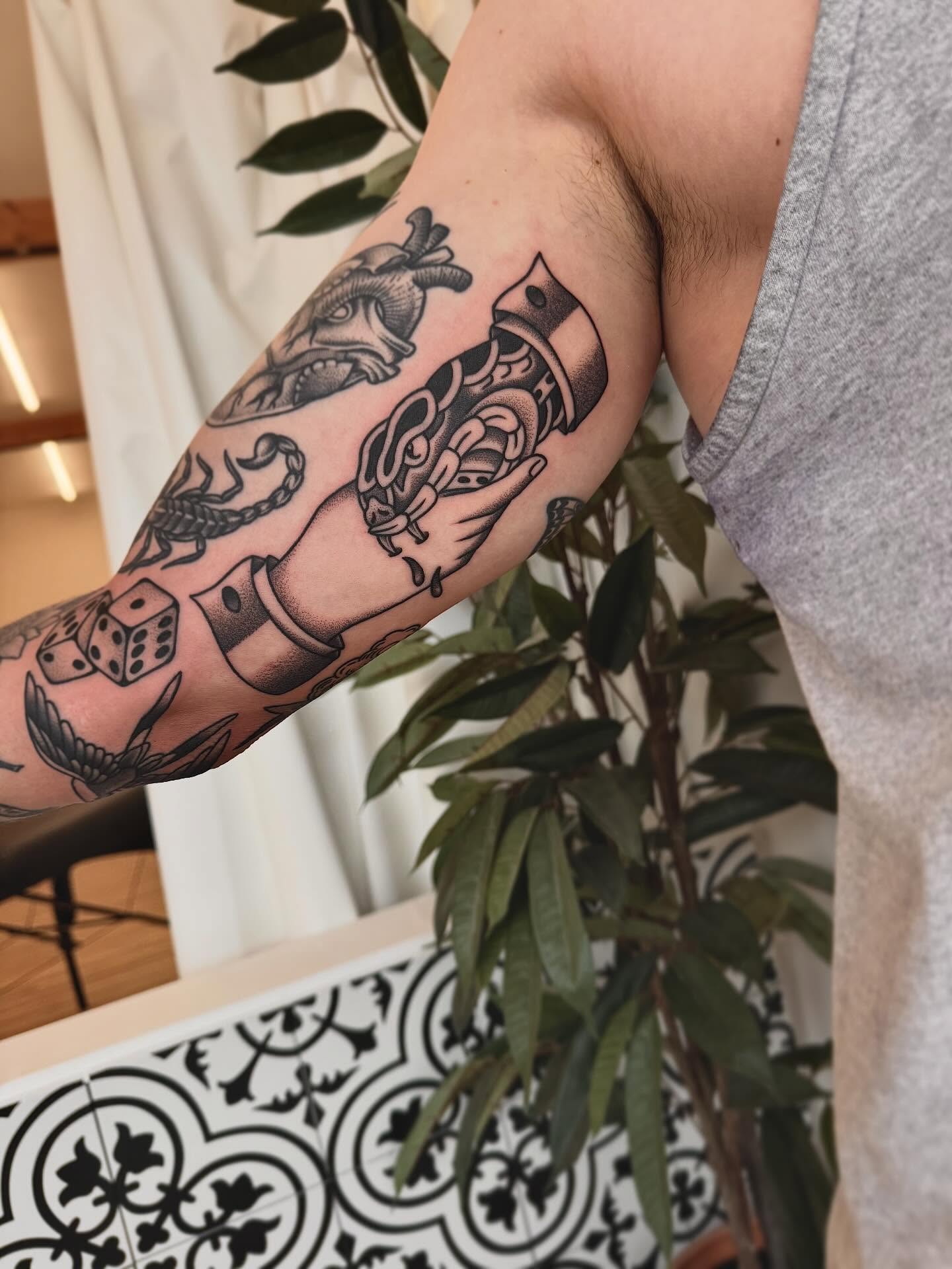 Dice, scorpion, heart, ship, hand American traditional tattoo on the forearm by Stefany