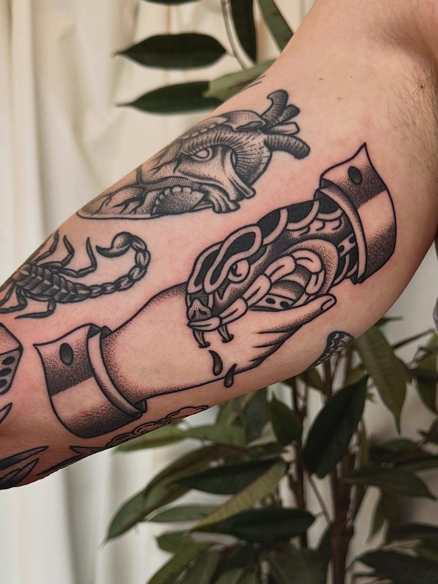 Snake and heart American traditional tattoo on the forearm by Stefany
