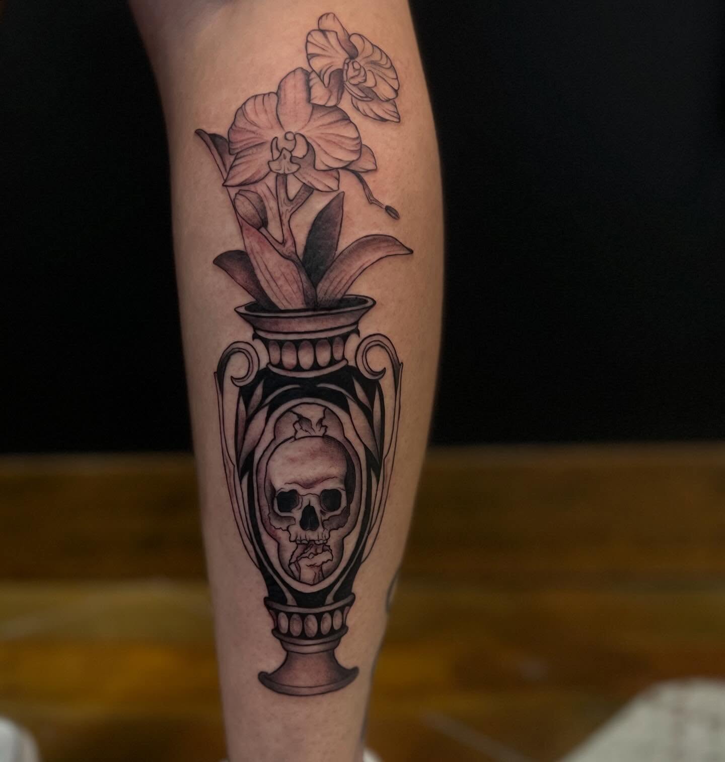 Vase with flowers and skull black and grey tattoo on the forearm by Rebecca Kern Tattoos
