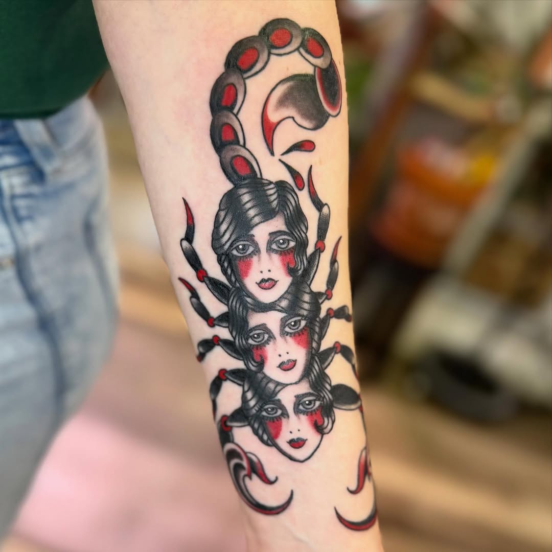 Scorpion with faces American traditional tattoo on the forearm by Rigo Vargas
