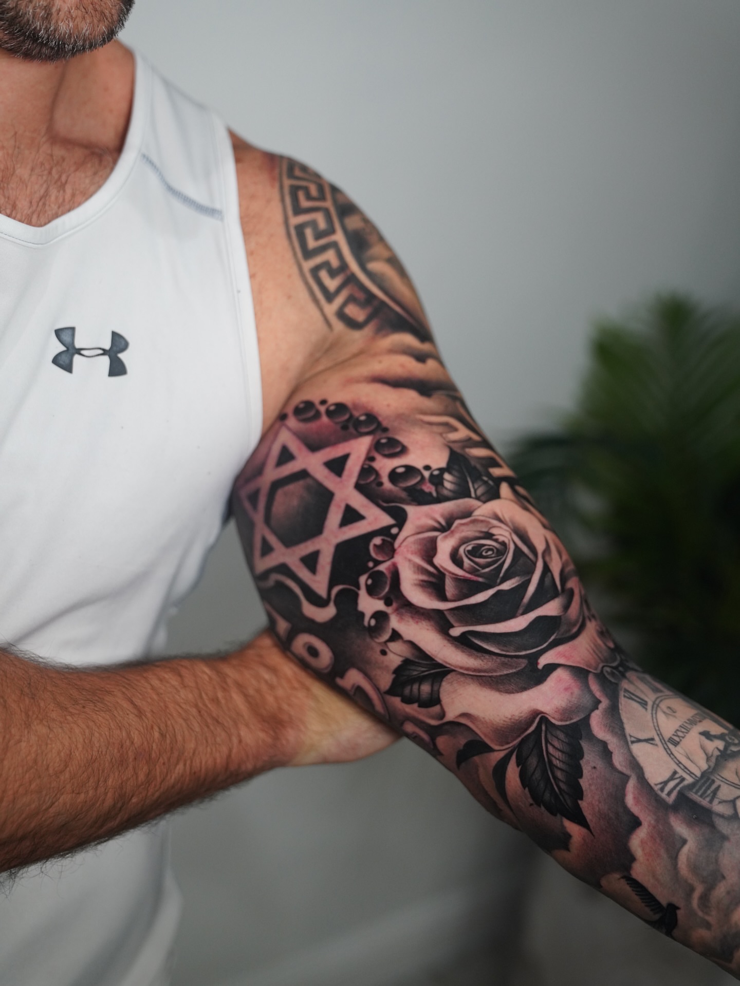 Rose and star of david realism tattoo on the forearm by Artem Kunakuzin