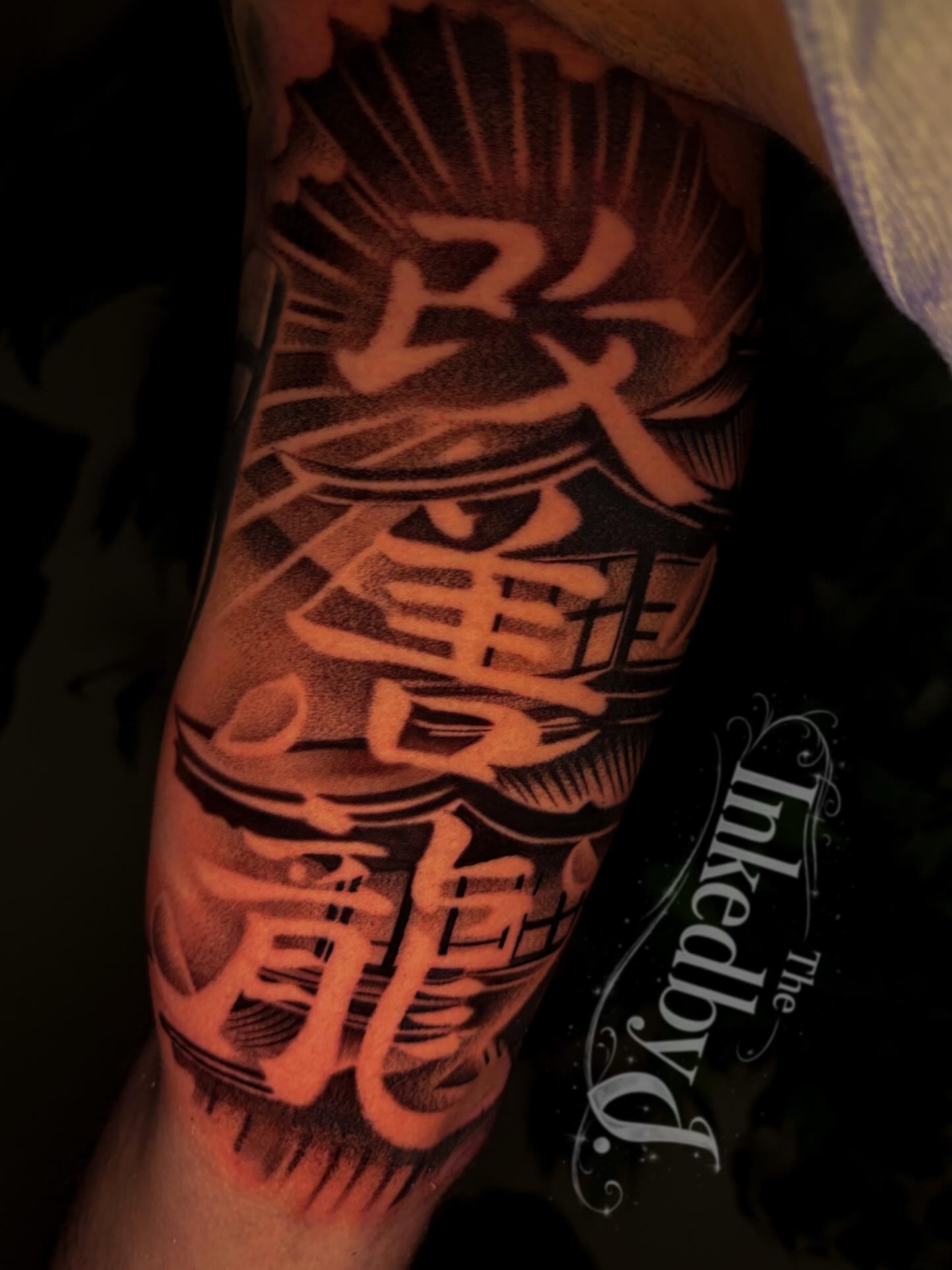 Kanji characters black and grey tattoo on the forearm by Jaylen - Atlanta Tattoo Artist