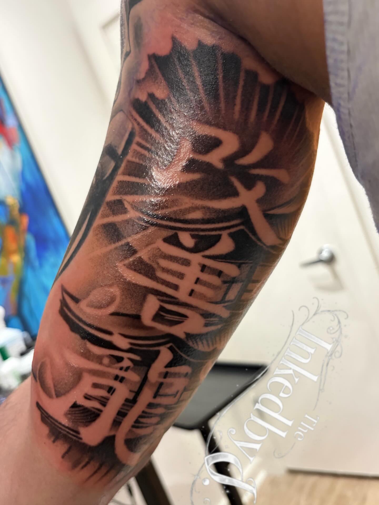 Kanji characters black and grey tattoo on the forearm by Jaylen - Atlanta Tattoo Artist