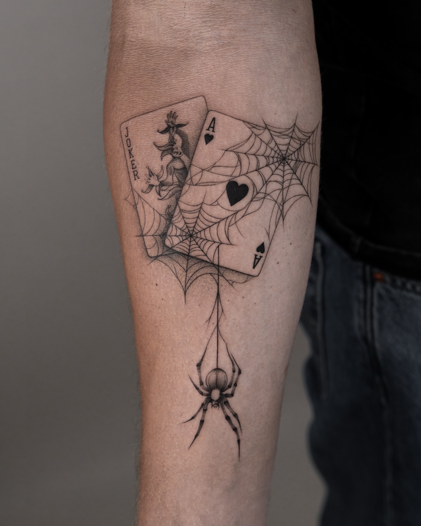 Playing cards and spiderweb geometric tattoo on the forearm by t y, t a t t o o a r t i s t