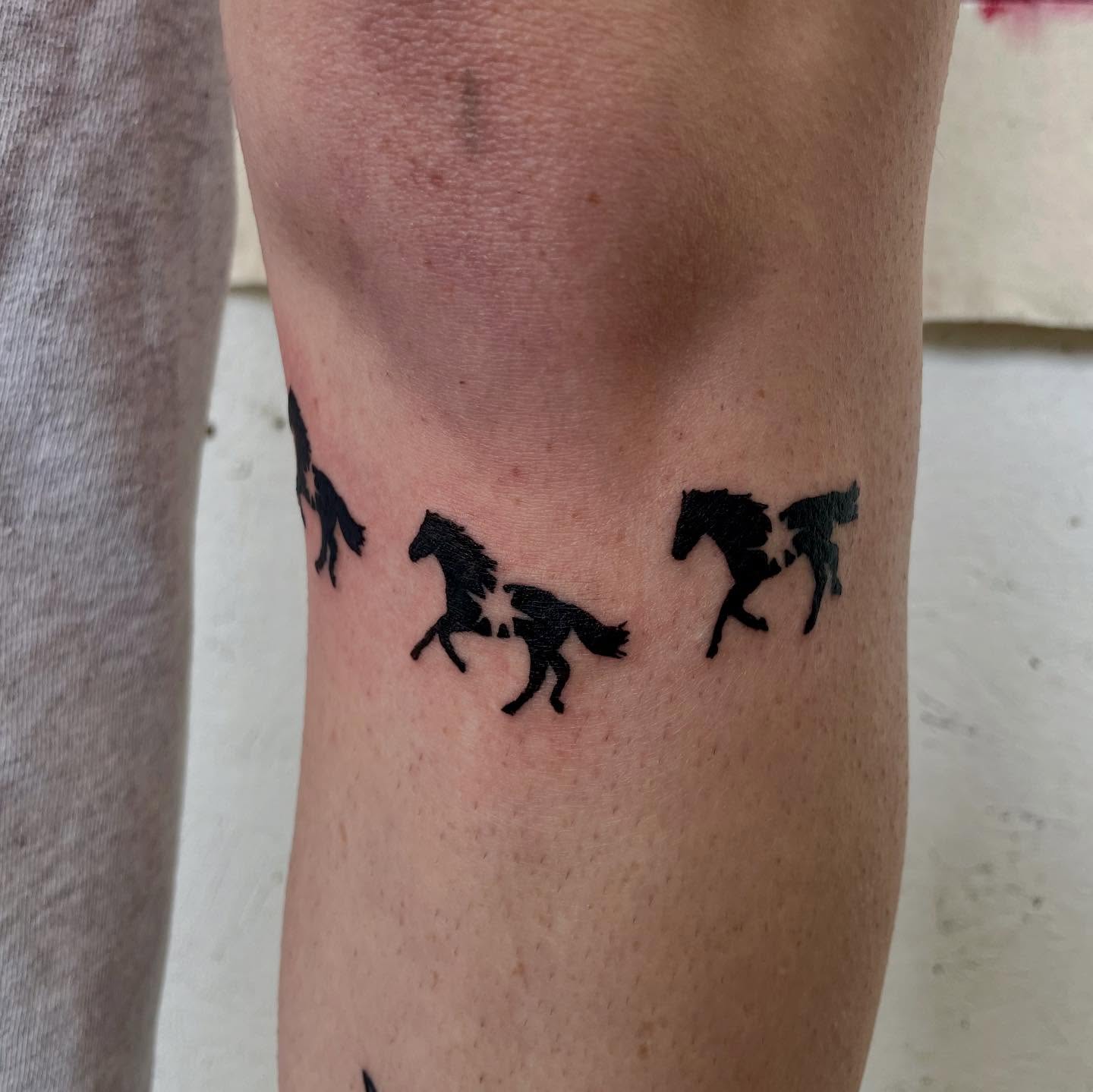 Horses black and grey tattoo on the calf by bisabuelita