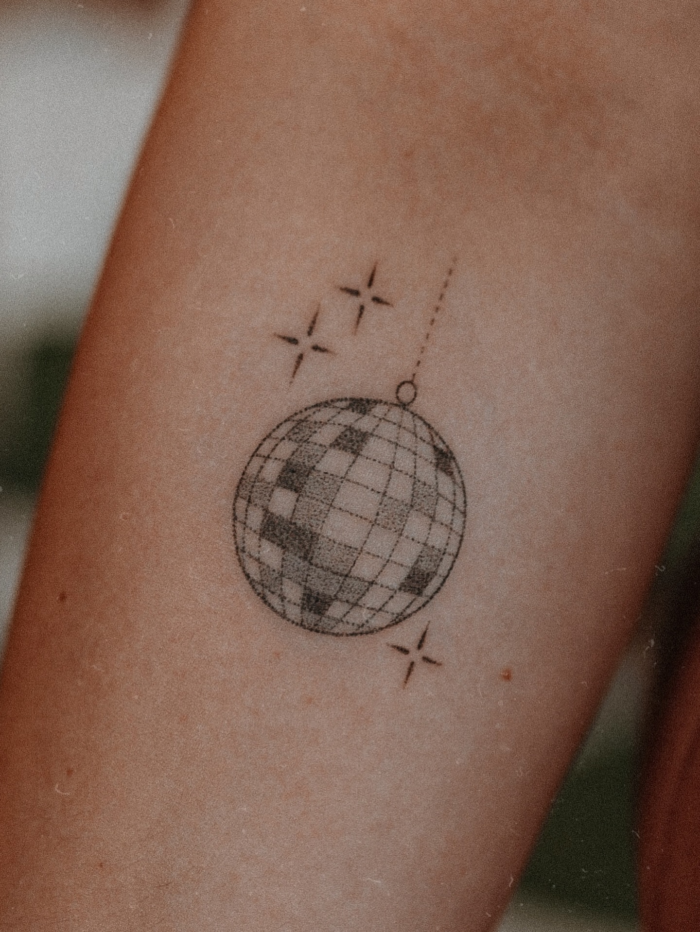 Disco ball geometric tattoo on the forearm by Grace Wise - Handpoke Tattoos