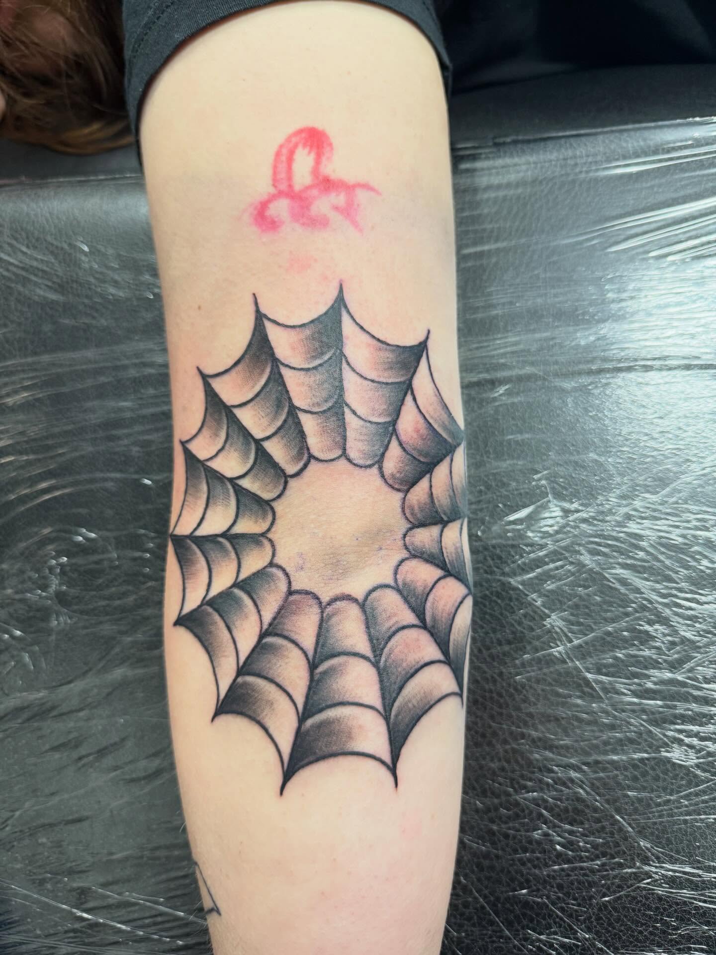Spider web geometric tattoo on the forearm by Daniel Smith