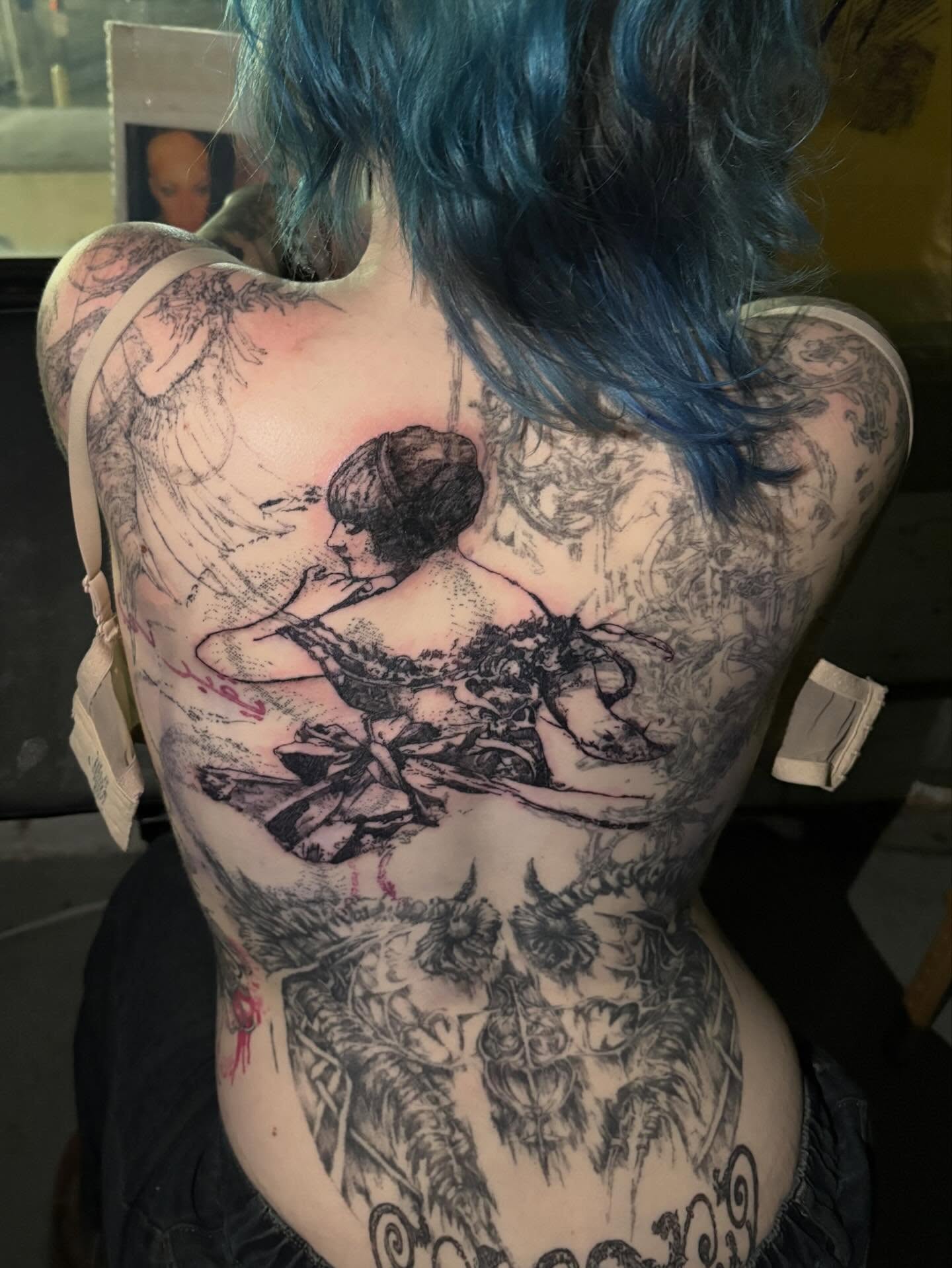 Woman with bird realism tattoo on the back by madeline
