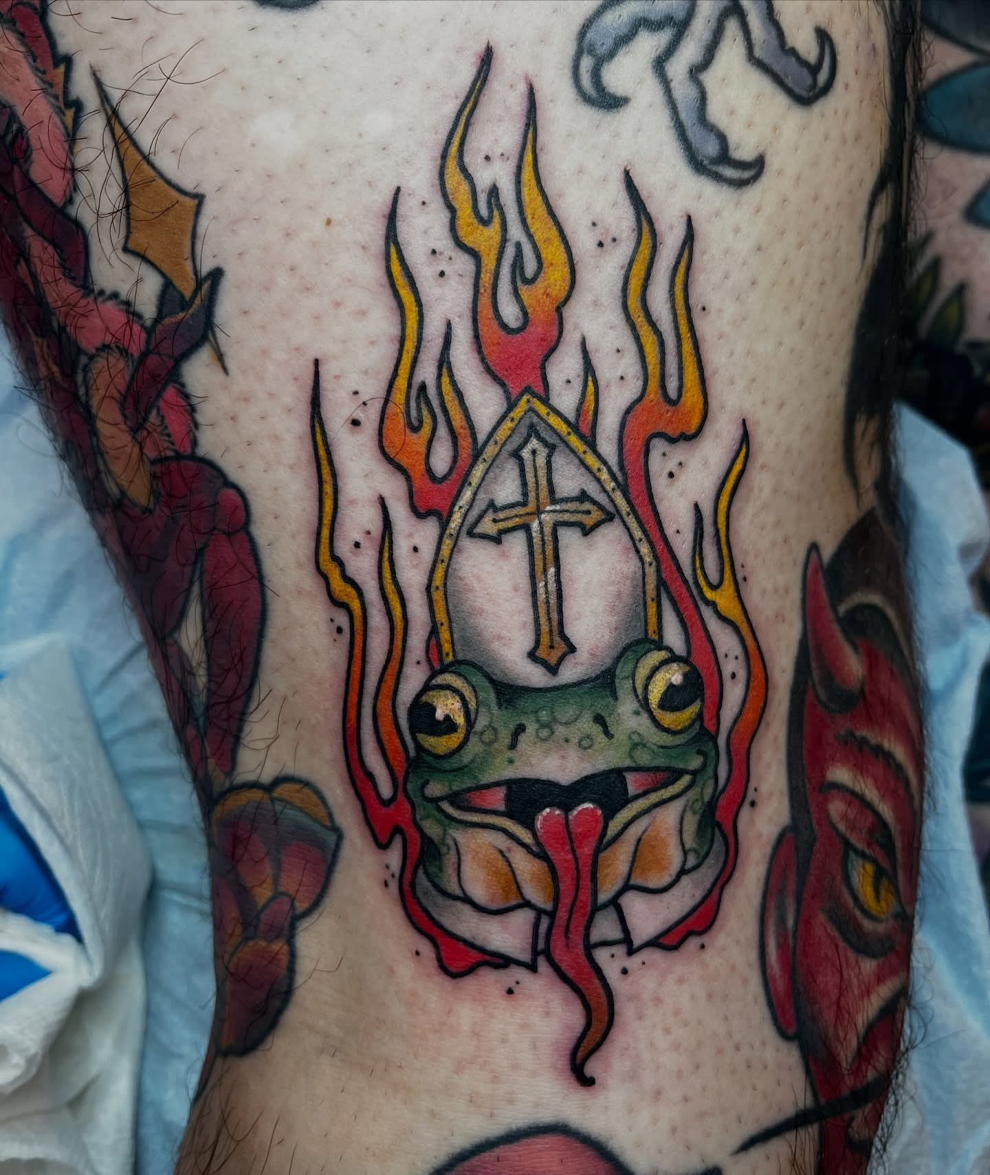 Frog with cross American traditional tattoo on the forearm by Kimber Teatro, Portland, Oregon