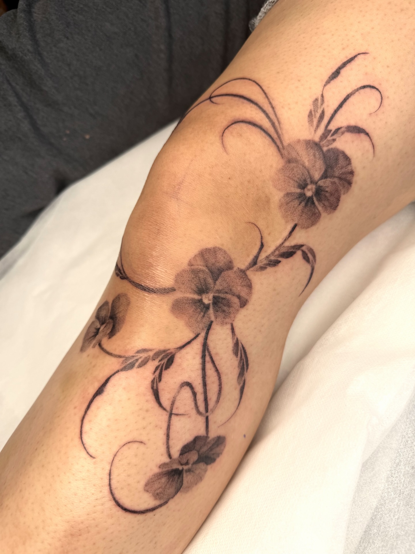 Floral design black and grey tattoo on the forearm by Red