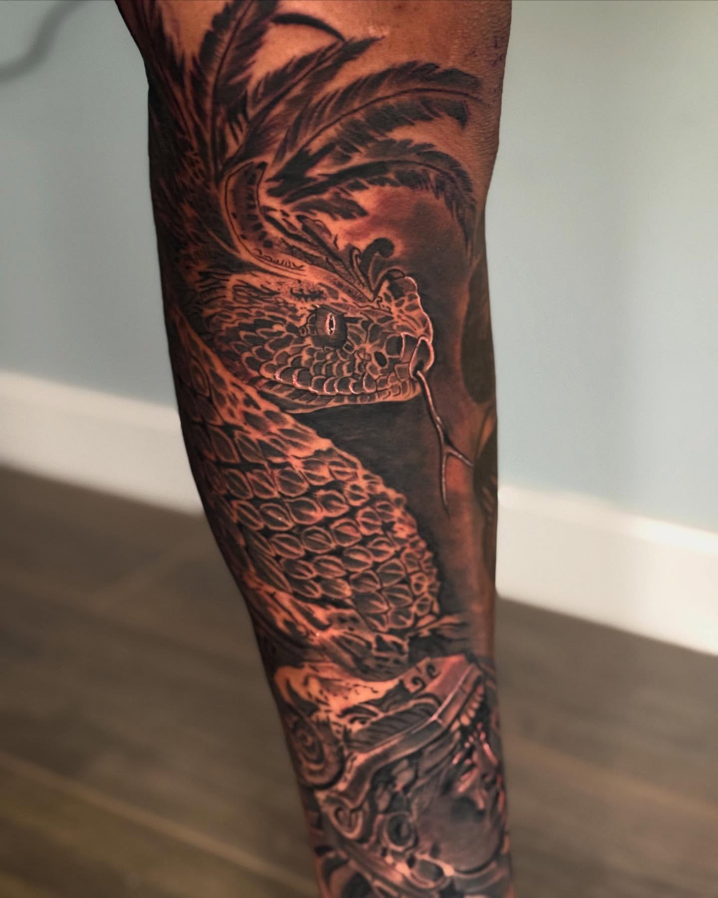 Snake black and grey tattoo on the forearm by Joseph Pacheco